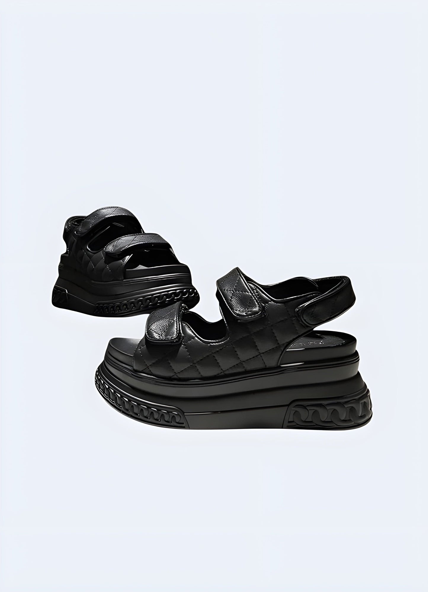 Front and side view of black platform chunky sandals, highlighting the eye-catching silhouette, secure ankle strap, and versatile style suitable for various occasions.