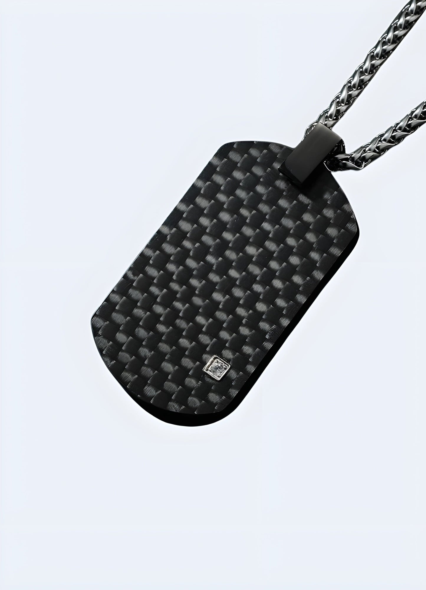 Front view of a carbon fiber techwear pendant from the UK, highlighting its sleek and modern design.