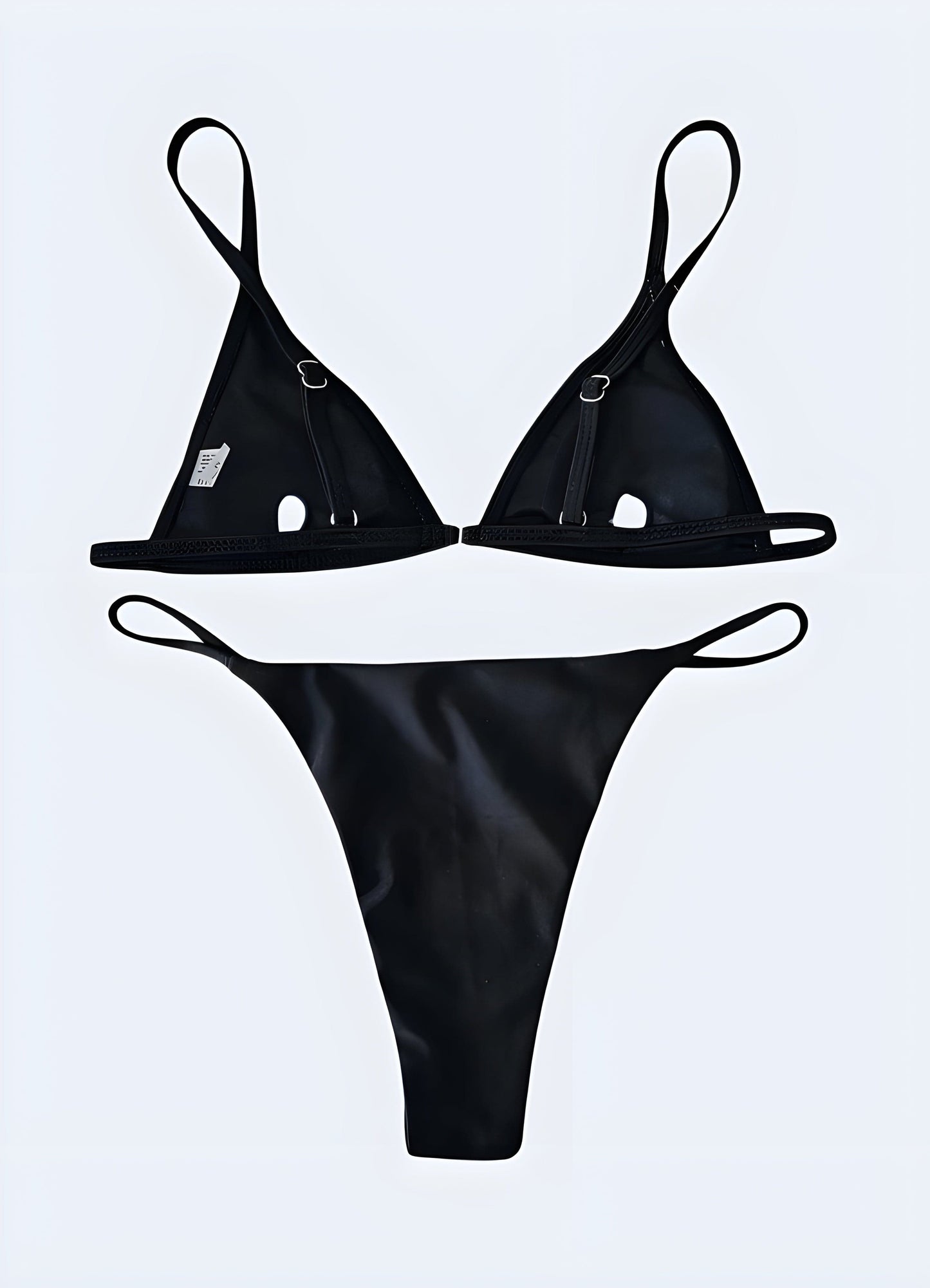 Rear view of a model wearing a goth bikini, showcasing intricate black straps and edgy design elements.