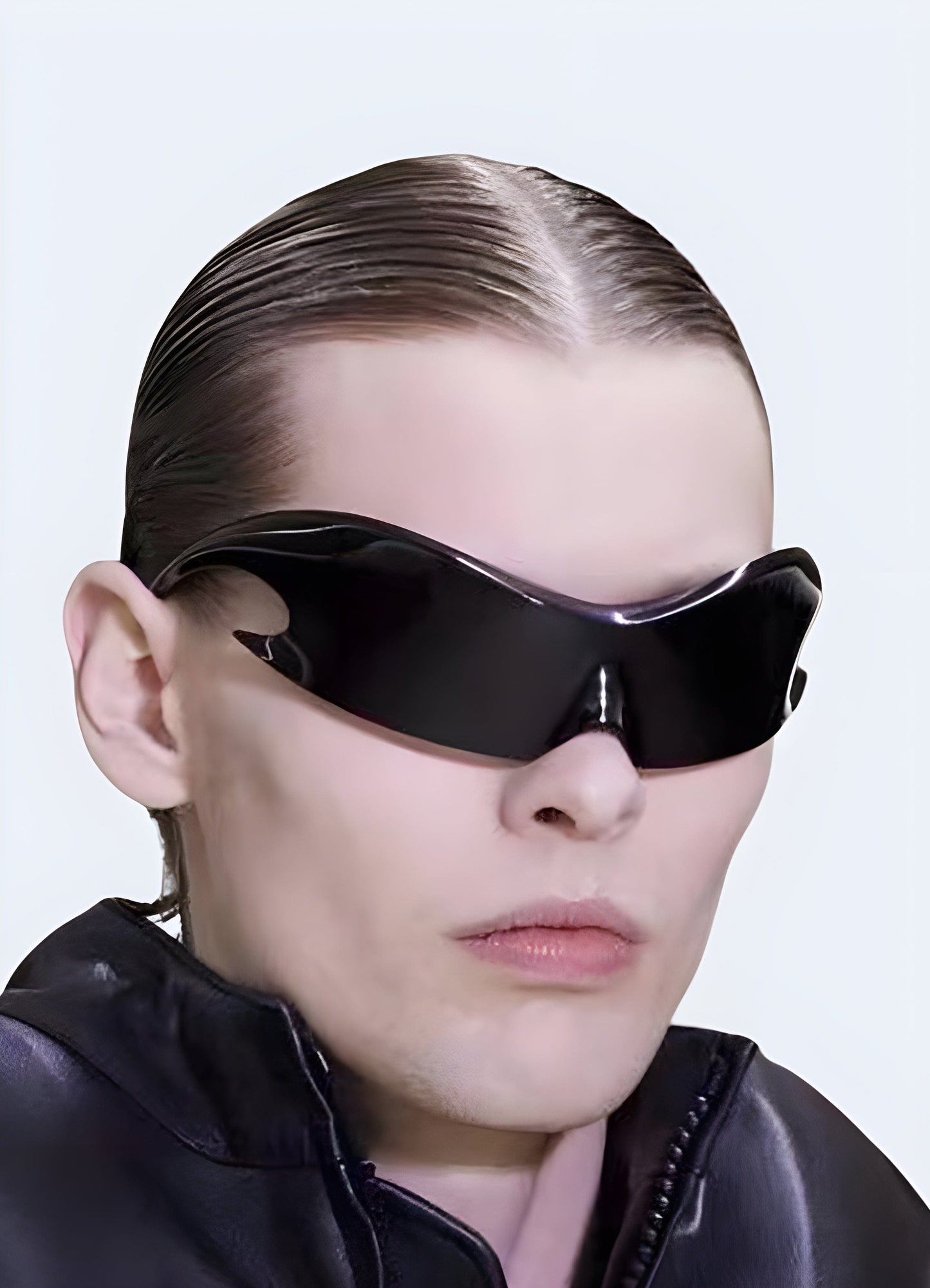 A man wearing a futuristic punk rock outfit viewed from the front, with a distinct UK aesthetic.