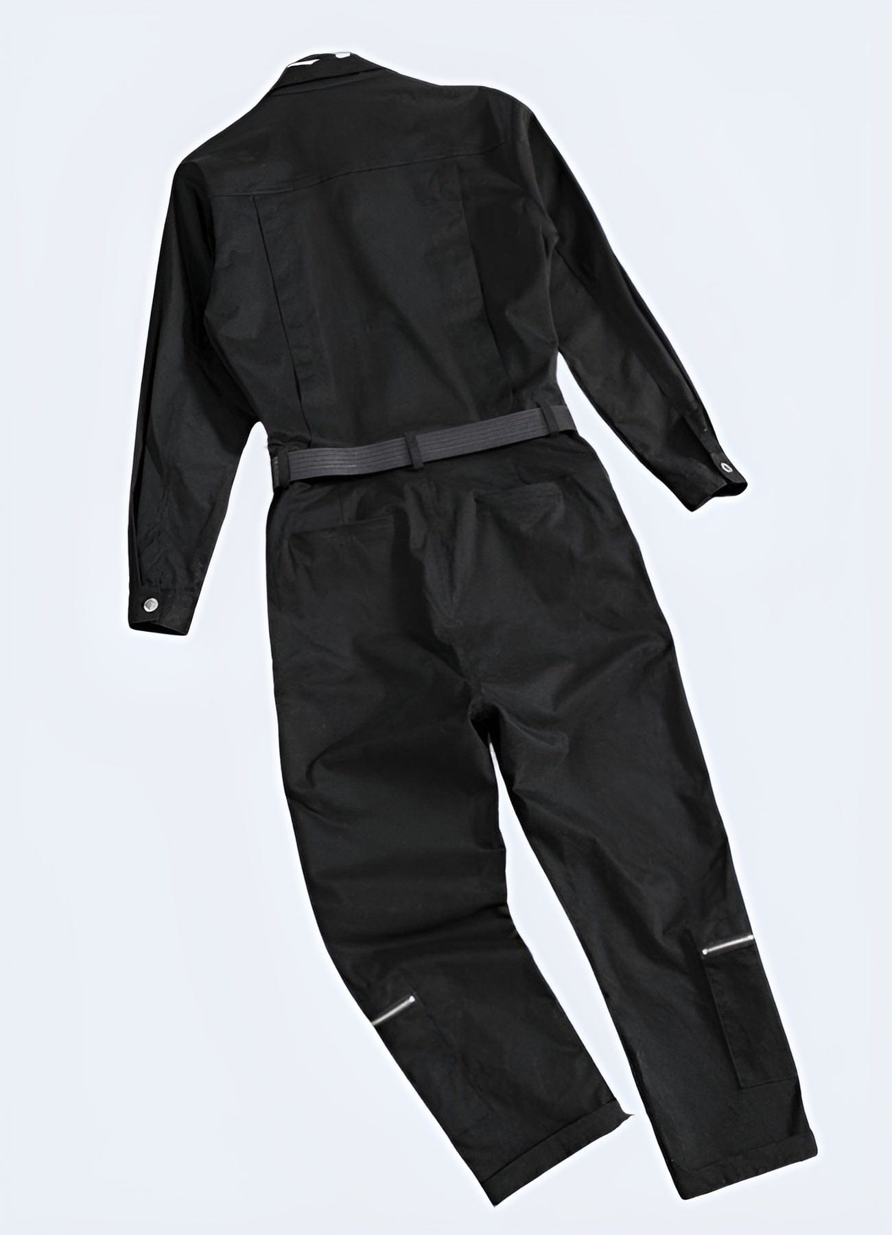 The coverall features a sleek, form-fitting silhouette with multiple functional pockets, reinforced knee panels, and adjustable cuffs.