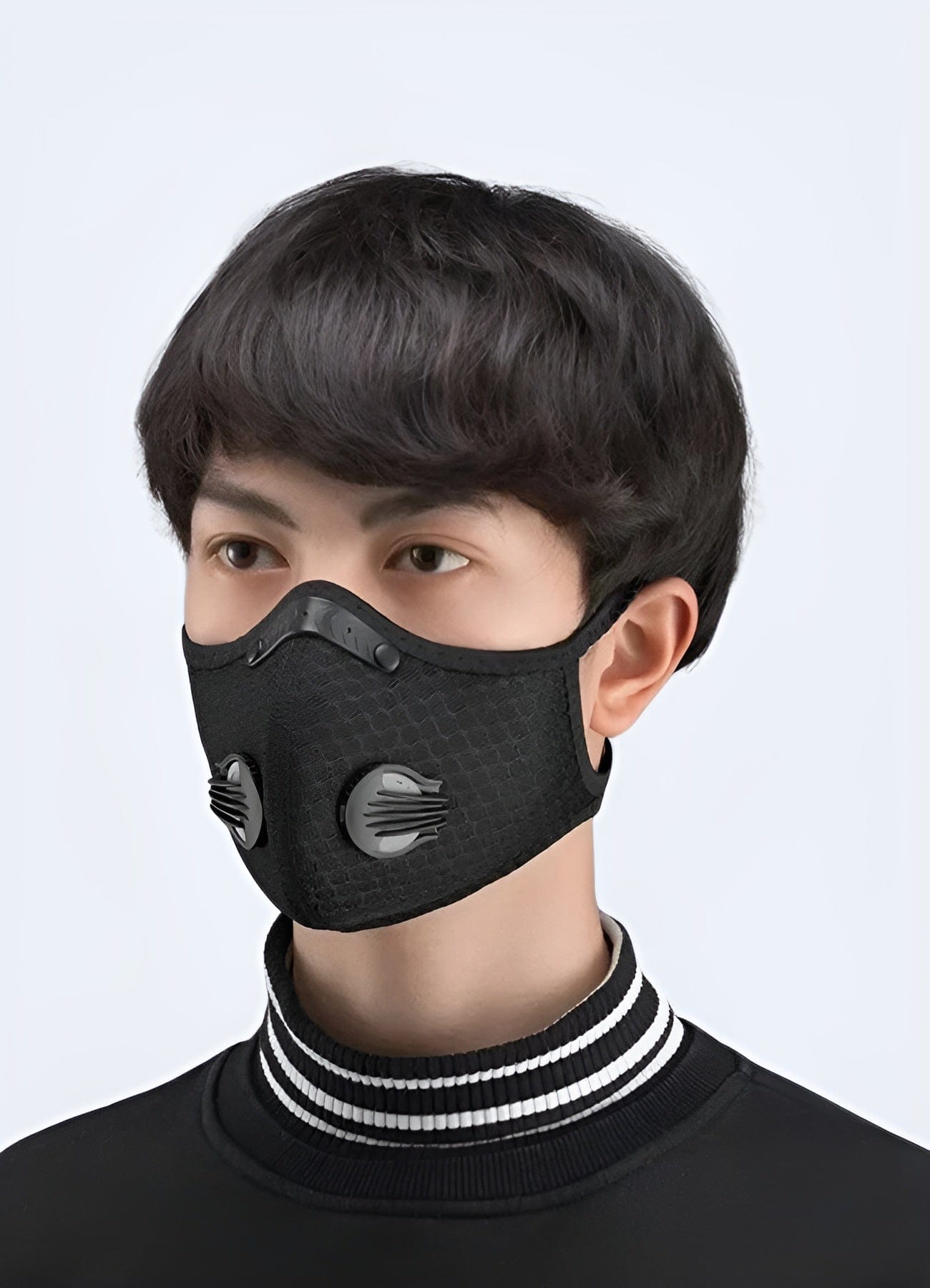 A man wearing an air pollution face mask, showing the side view, designed for optimal protection and comfort, available in the UK.
