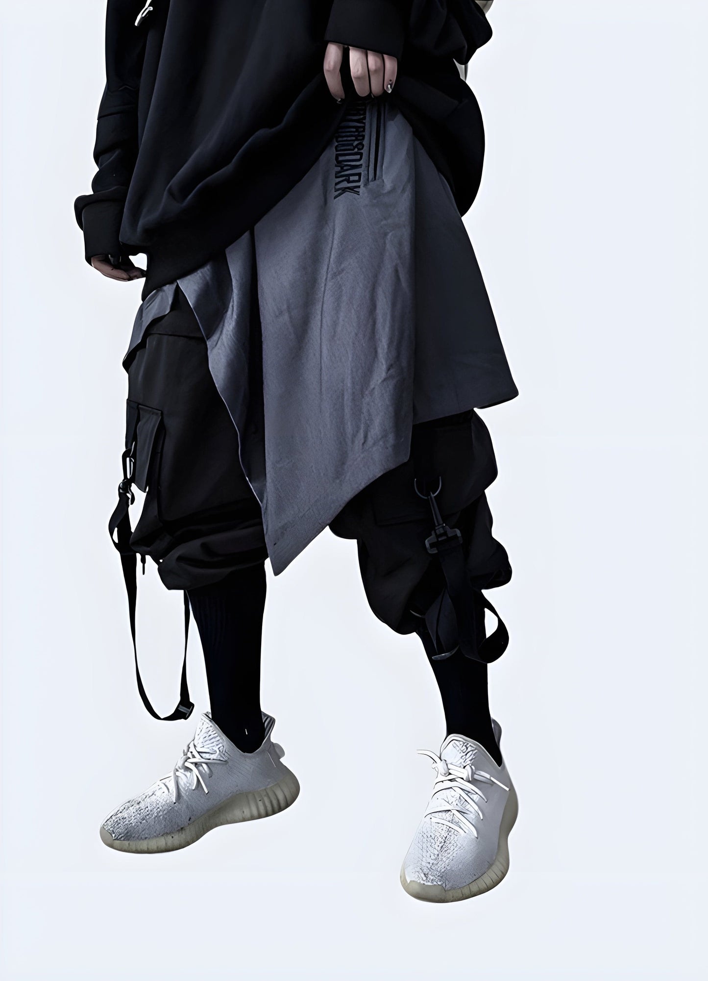 Front side view of a man modeling stylish gray techwear harem pants, highlighting the advanced fabric technology and modern aesthetics, a must-have for fashion-forward techies in the UK.
