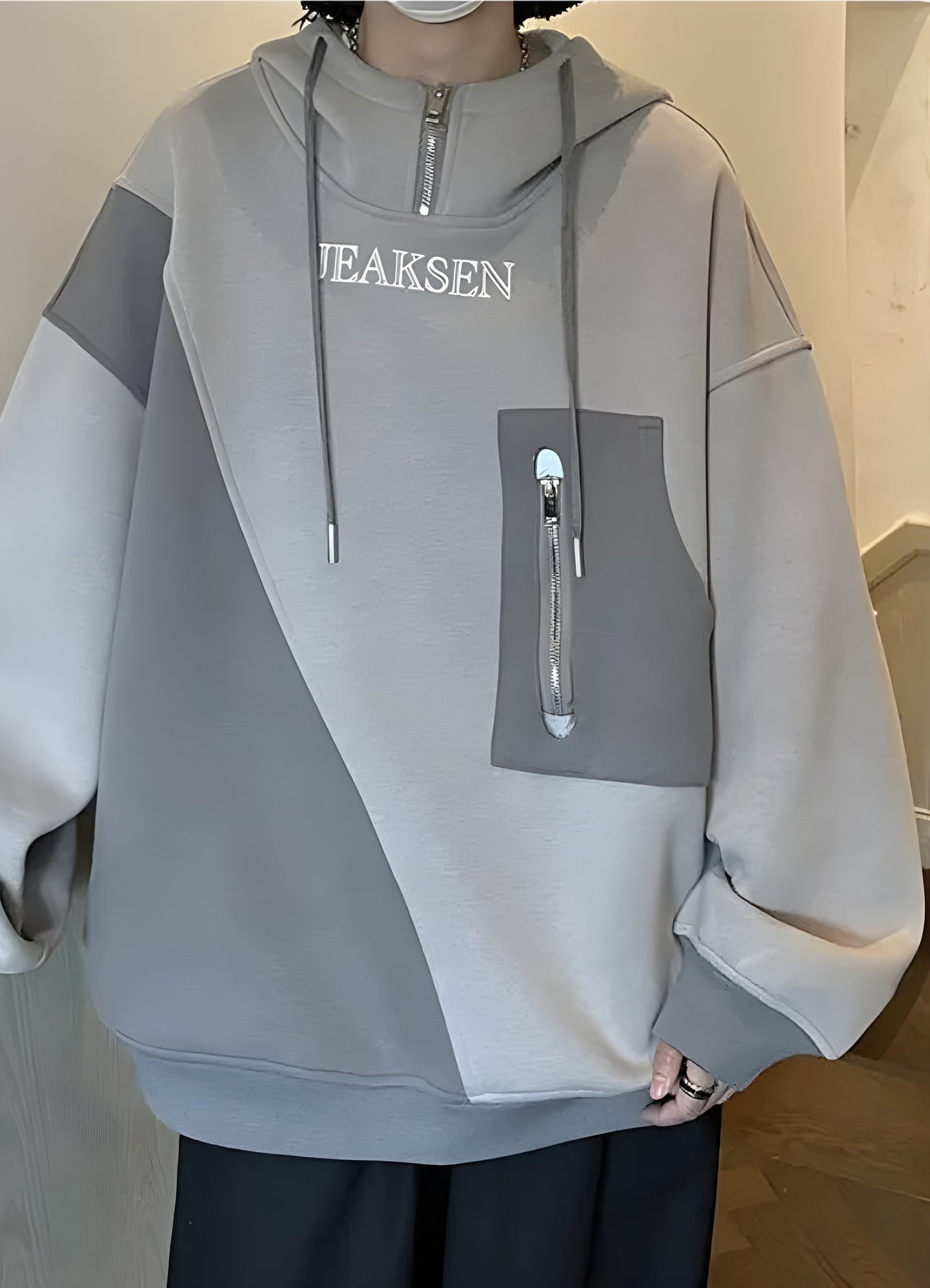 Front view of a multi-pocket hoodie featuring numerous compartments and zippers, providing ample storage space and easy access to essentials for those on the go or engaging in outdoor activities.