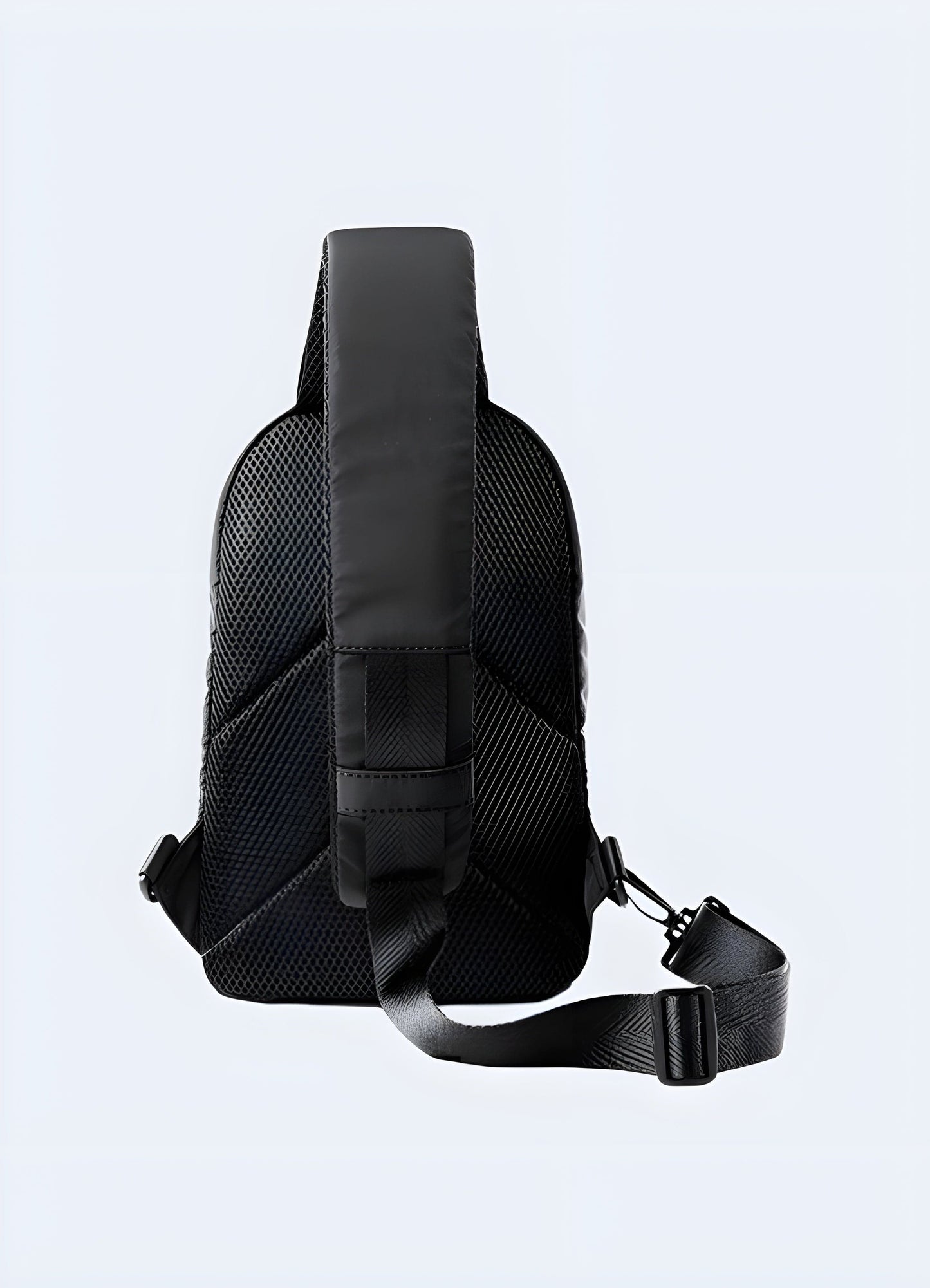 Small black sling bag, back view. Compact and stylish, this bag offers a sleek design ideal for everyday use. Its adjustable strap and minimalist look make it a versatile accessory for techwear and streetwear enthusiasts. Perfect for carrying essentials in a trendy, hands-free way.