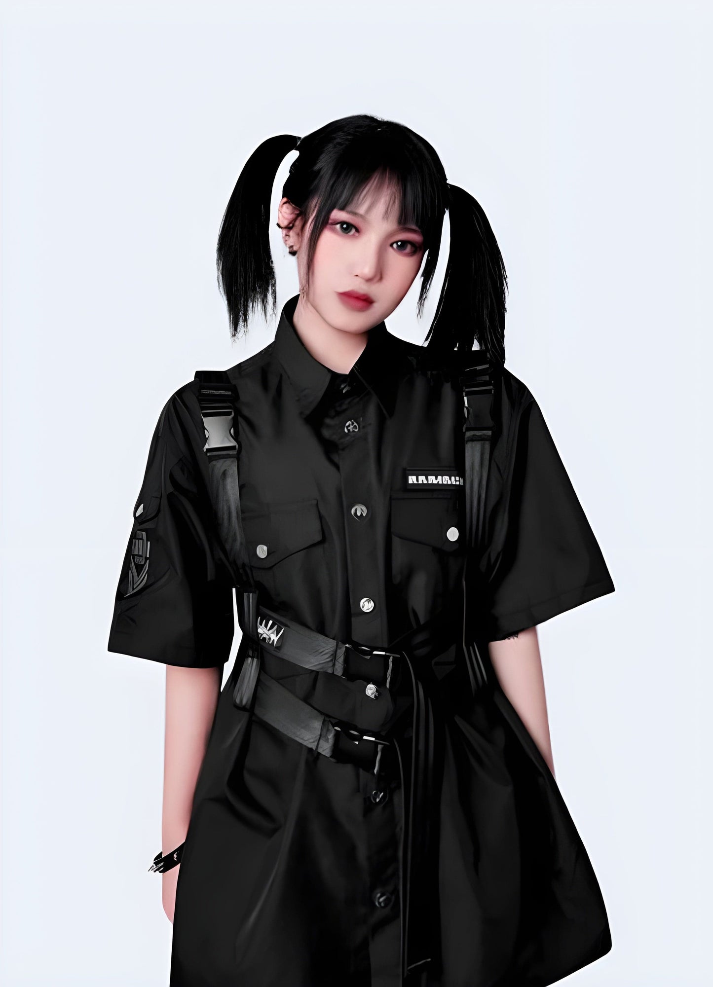 Woman wearing techwear tactical shoulder strap, front view, UK. Stylish and practical for urban settings.