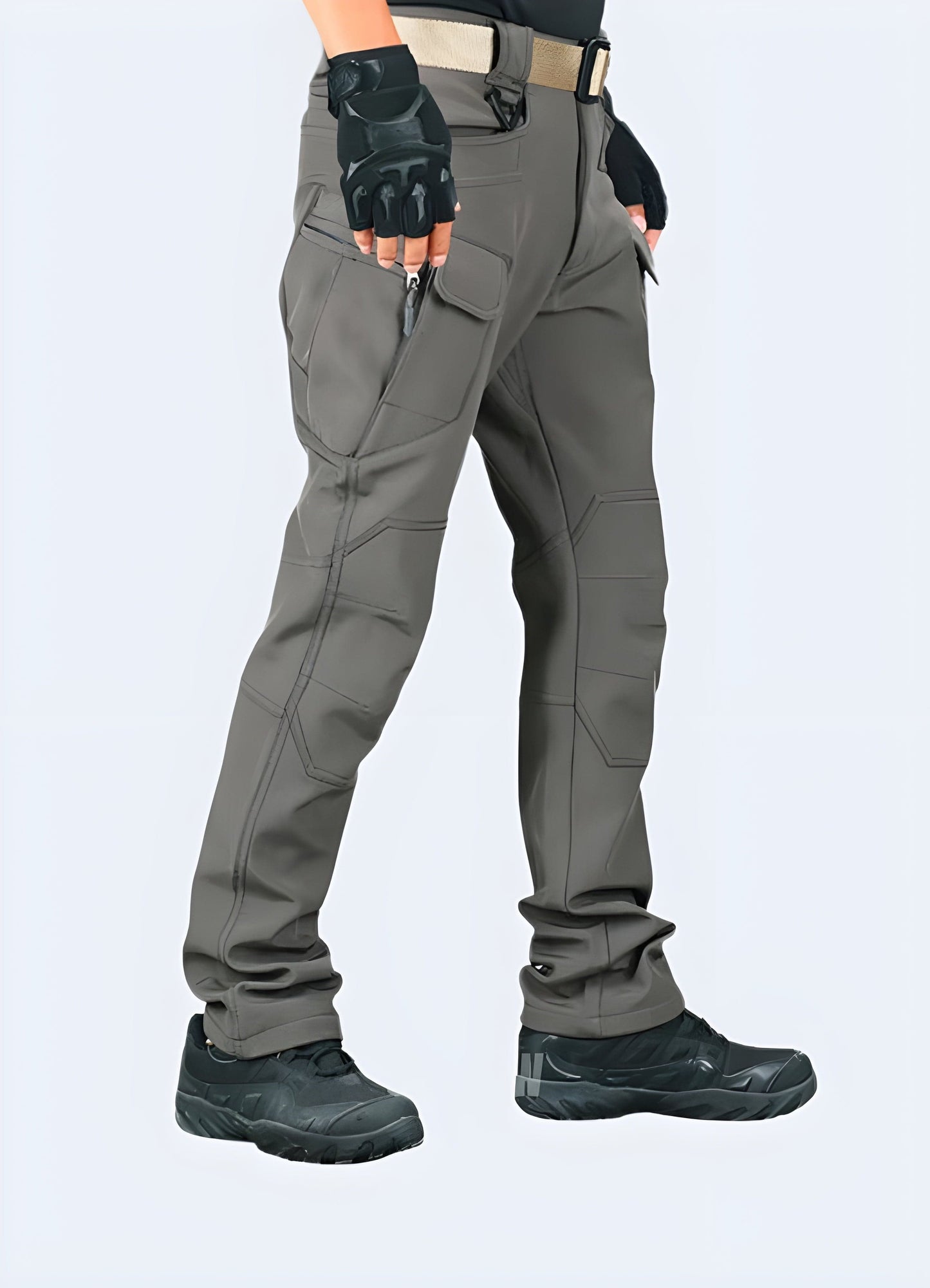 Side view of a man modeling stylish gorpcore pants, emphasizing the garment's practical design and modern aesthetics, a must-have for UK individuals embracing the gorpcore fashion trend.
