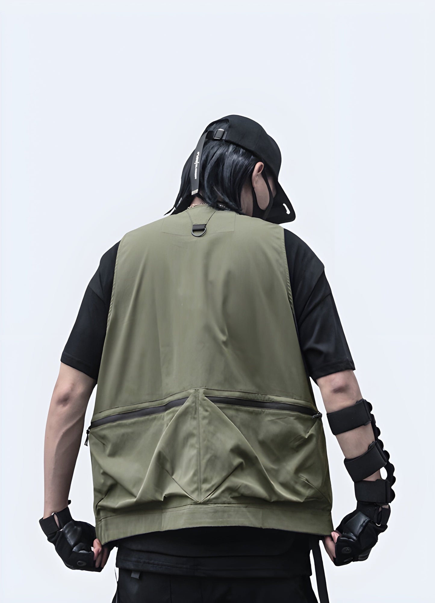 Rear view of a man wearing a groundbreaking black vest featuring built-in speakers and LED illumination, designed for outdoor use in the UK.