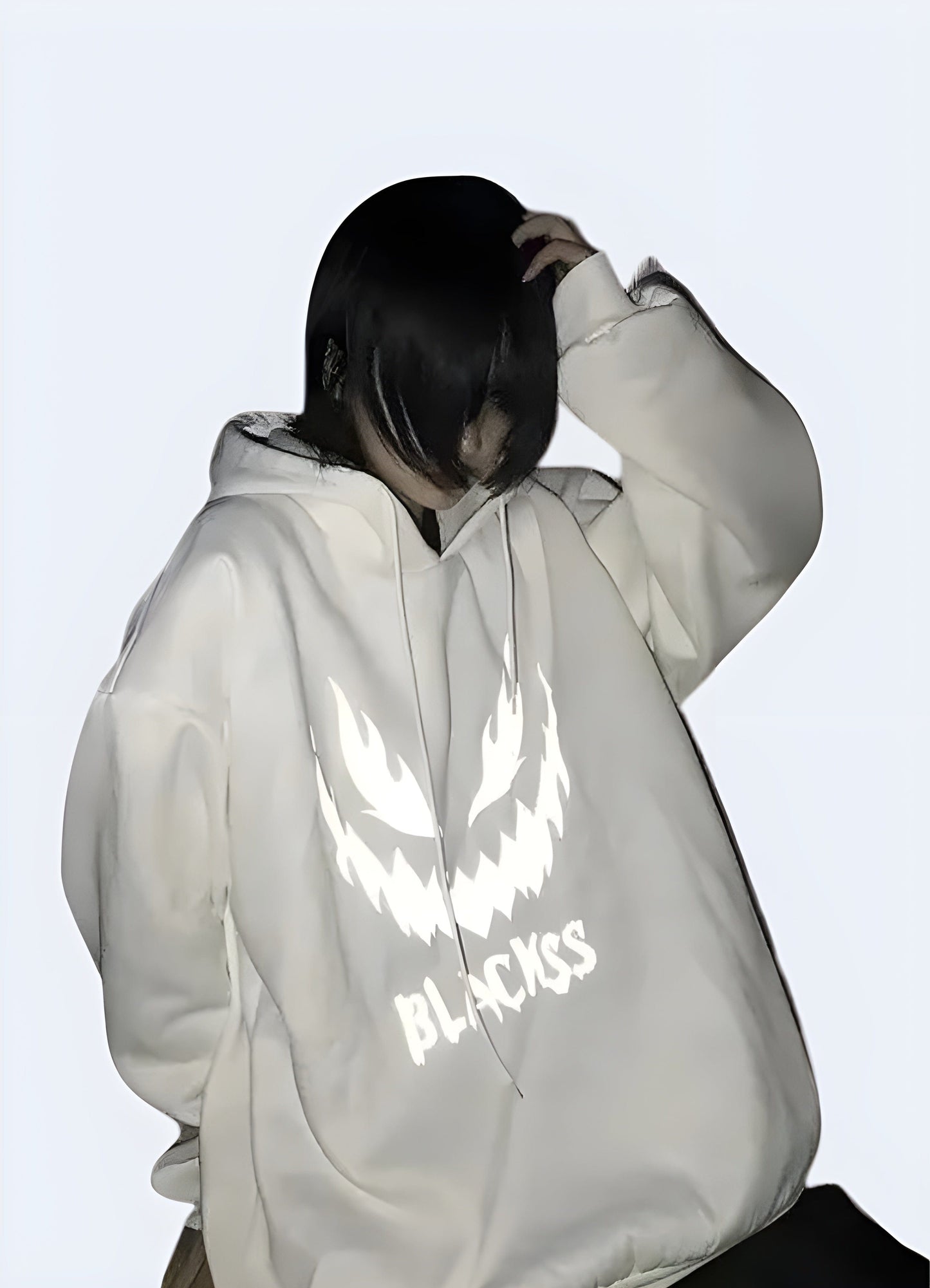 Man wearing a white reflective hoodie, front view, showcasing the garment's reflective features, available in the UK