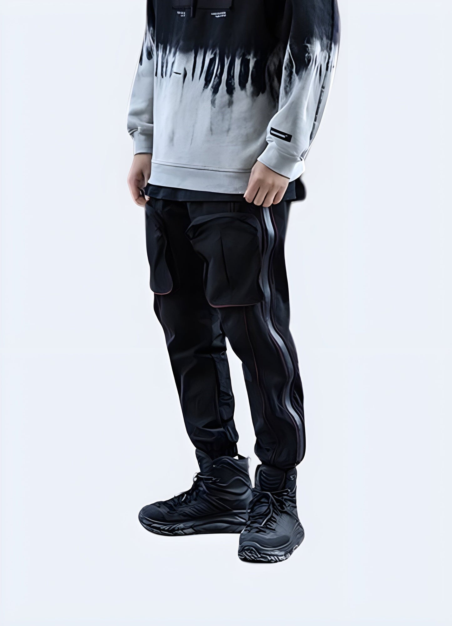 Model showcasing black avant-garde cargo pants from the front view, ideal for men seeking cutting-edge style in the UK fashion scene.