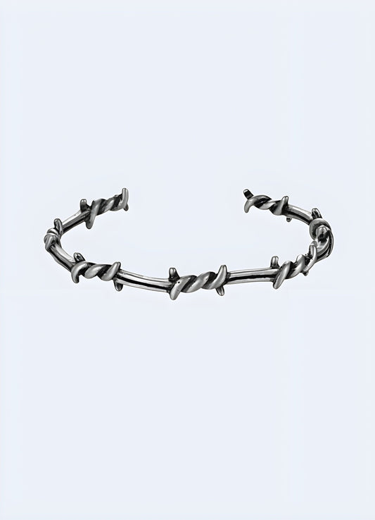 Close-up view of a barbed wire bangle available in the UK.