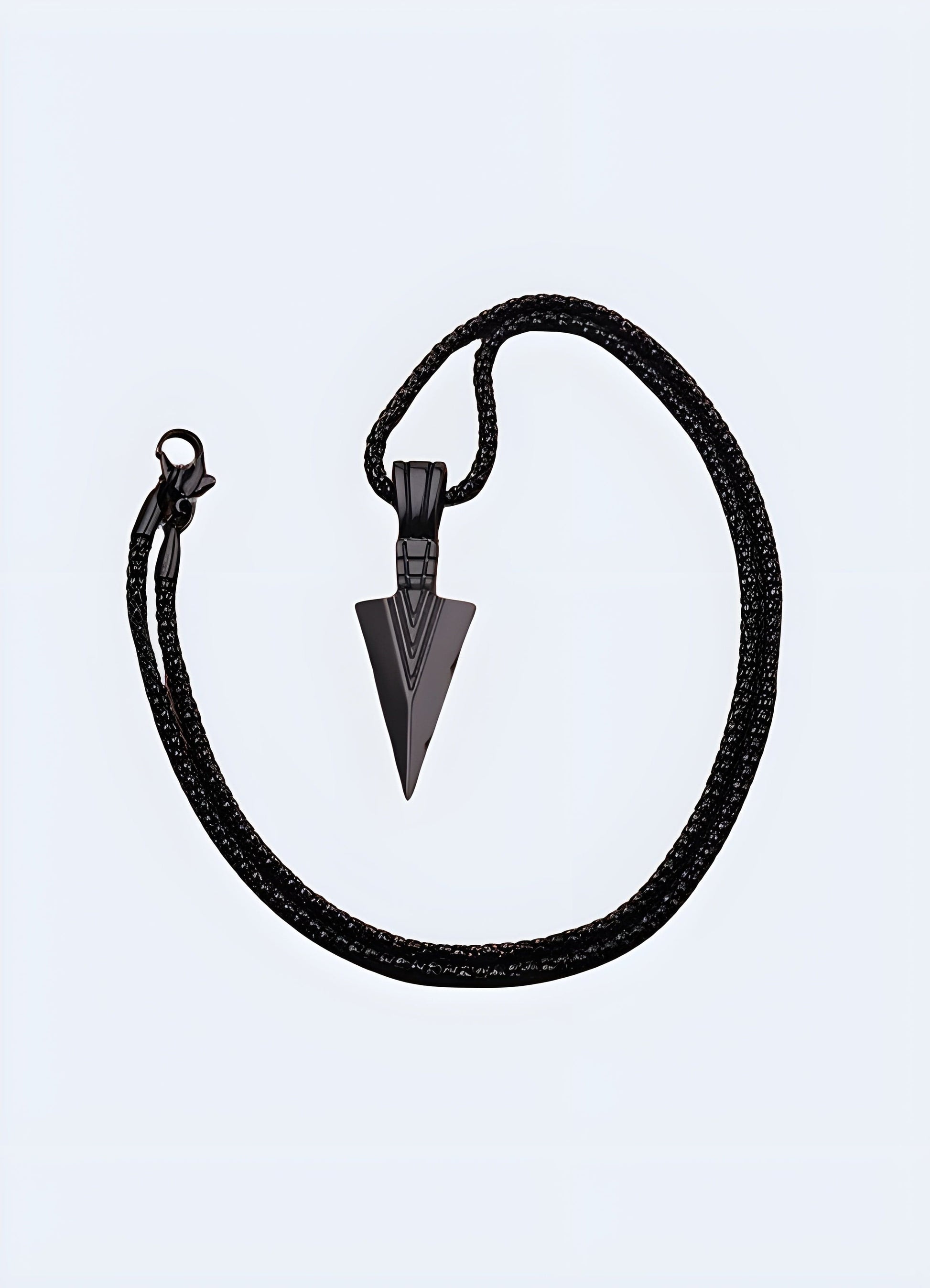 Side view of a fashionable black arrowhead necklace on a model in the UK.