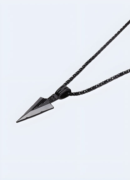 Side view of a black arrowhead necklace worn by a model in the UK.