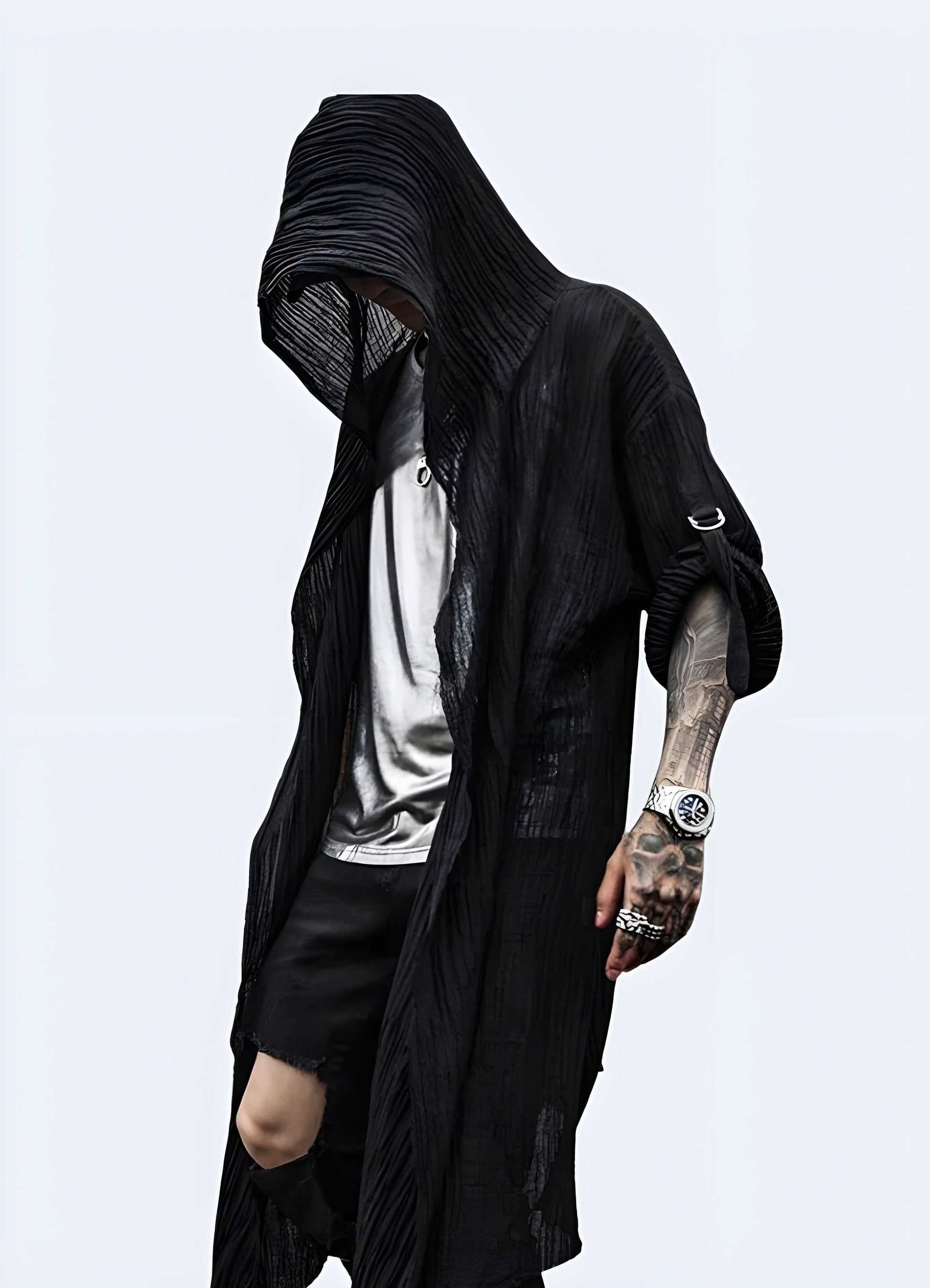 Front view of a man wearing a black cloak with a hood, showcasing its mysterious and edgy style for a bold fashion statement in the UK.