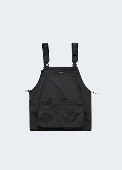 Back view of a black tactical vest showcasing its multiple utility pockets, adjustable fit, and versatile design, suitable for urban fashion and functional wear.