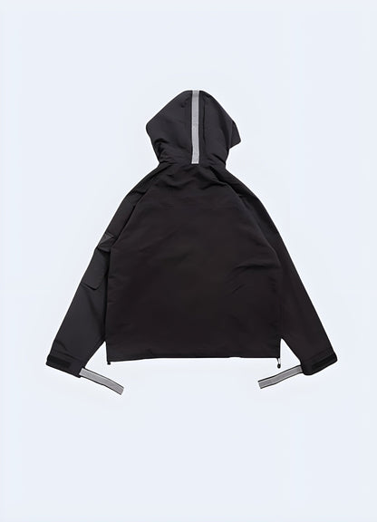 Back view of a black techwear jacket, showcasing its advanced materials and ergonomic design for optimal functionality.