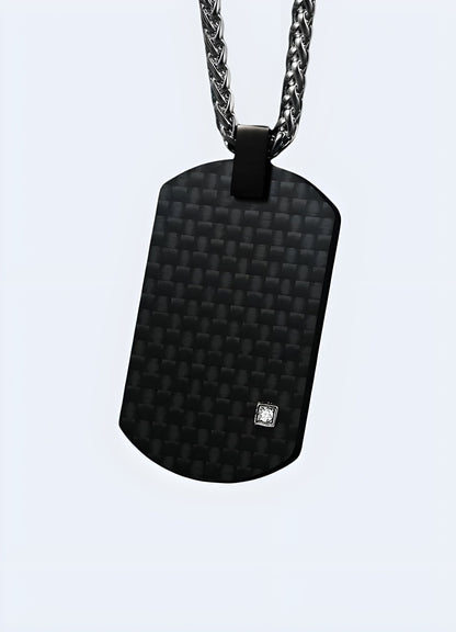 Front view of a black carbon fiber techwear pendant from the UK, showcasing its sleek and futuristic design.