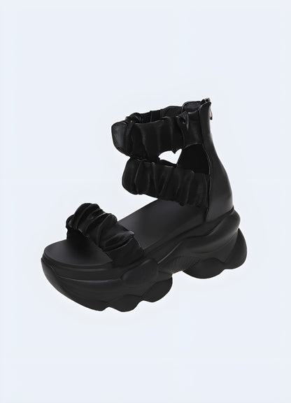 Chunky black sandal with a bold and modern design, perfect for adding an edgy and stylish touch to any summer outfit while ensuring comfort and support.