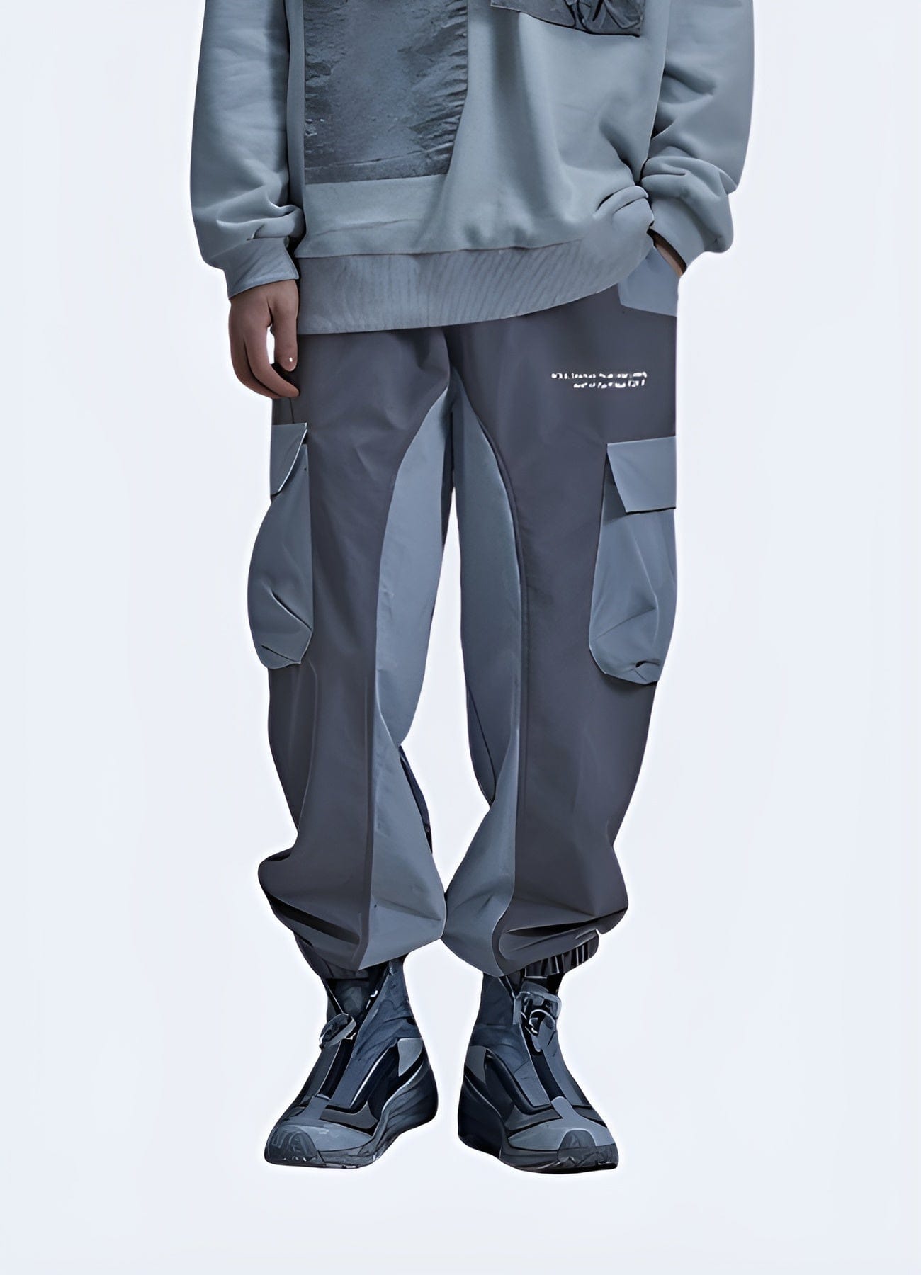 Man wearing grey cyberpunk joggers, front view, futuristic streetwear fashion in the UK.