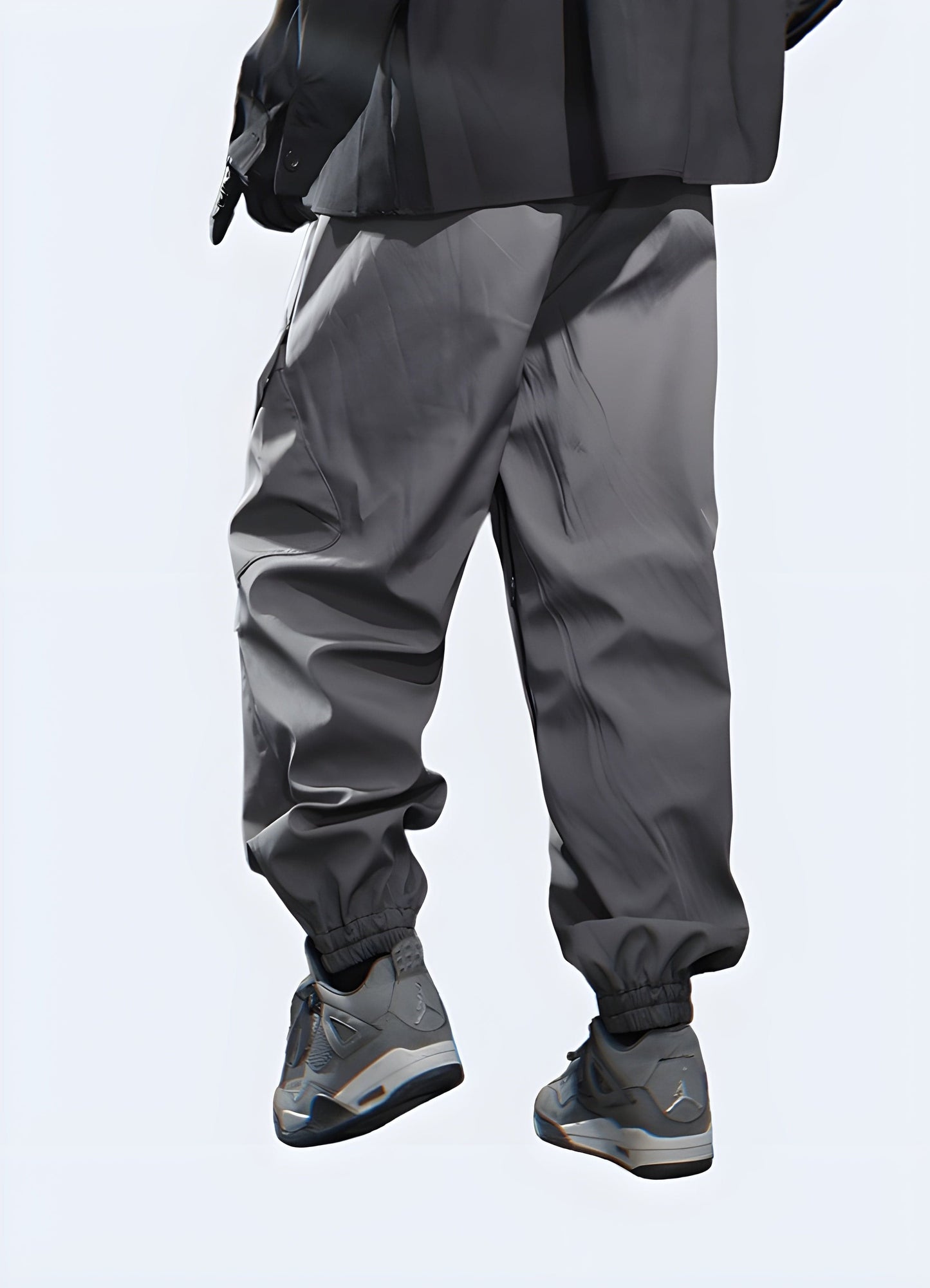 A rear view of a pair of fashionable dark grey cargo trousers, highlighting the garment's clean lines and functional pockets, perfect for the fashion conscious in the UK.