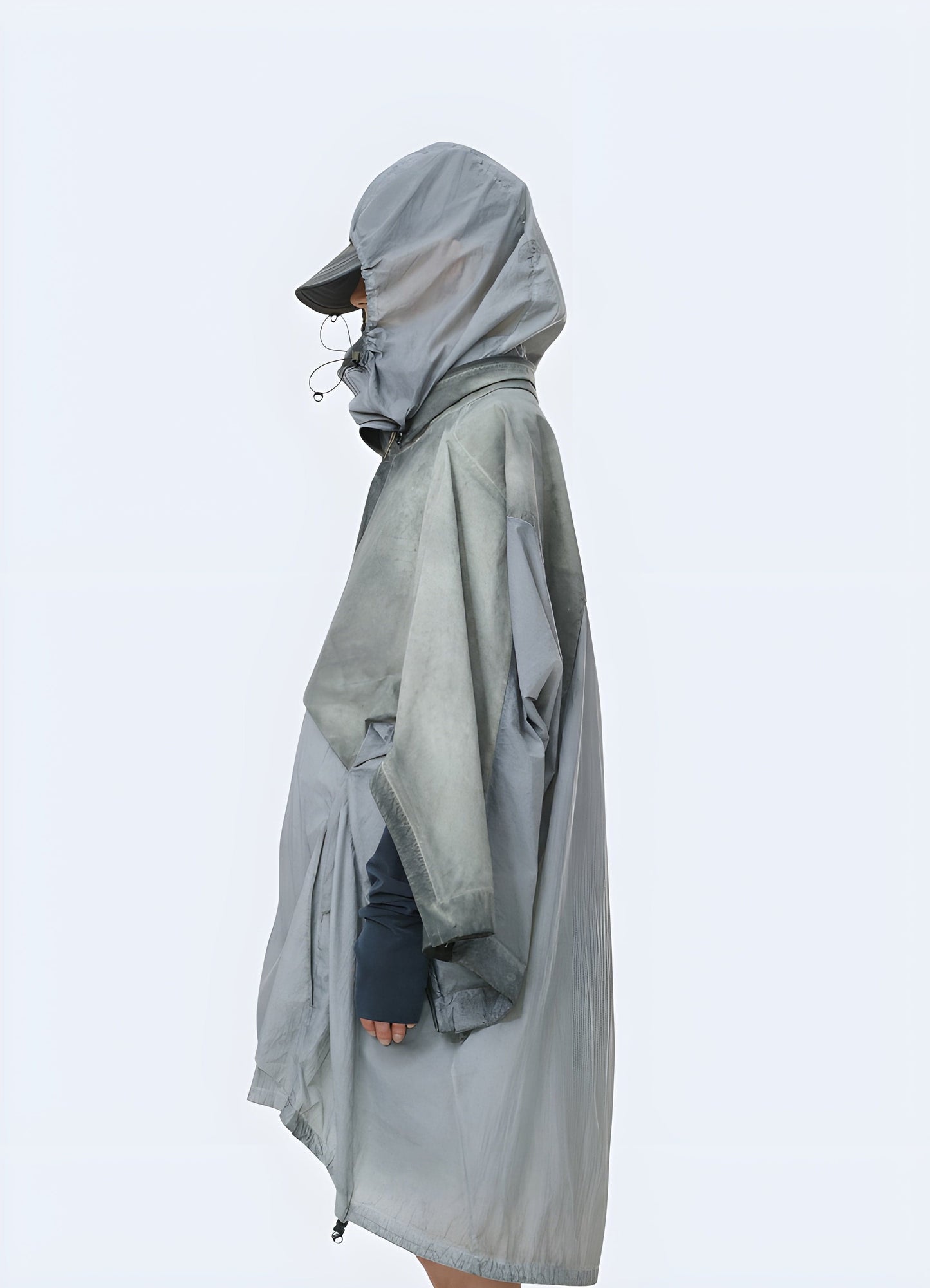 Side view of a man wearing an apocalypse poncho, highlighting the unconventional design and weathered appearance, suitable for the UK fashion-forward individual embracing the post-apocalyptic look.