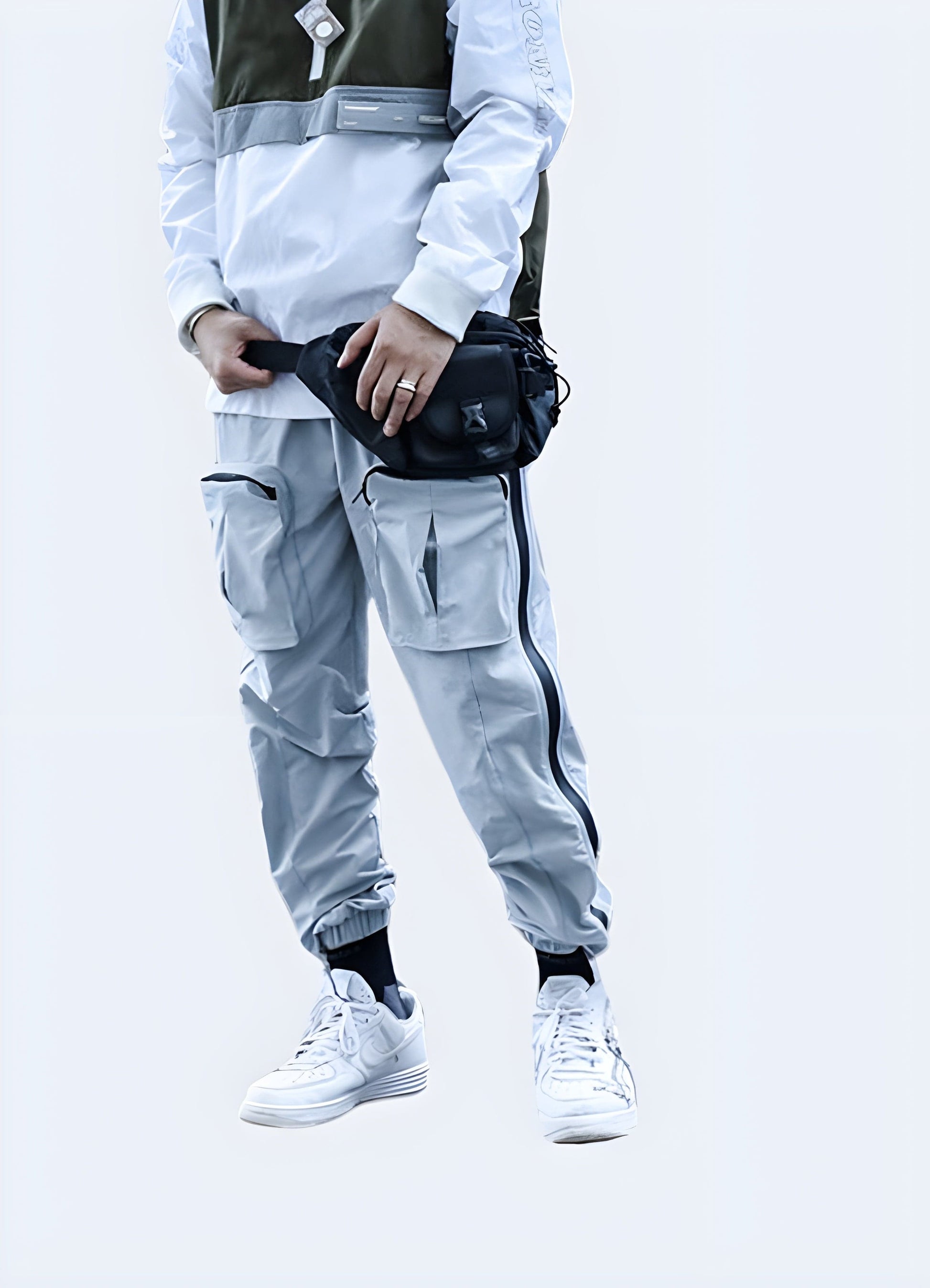 Male model wearing gray avant-garde cargo pants from the front view, showcasing innovative design perfect for fashion-forward men in the UK.