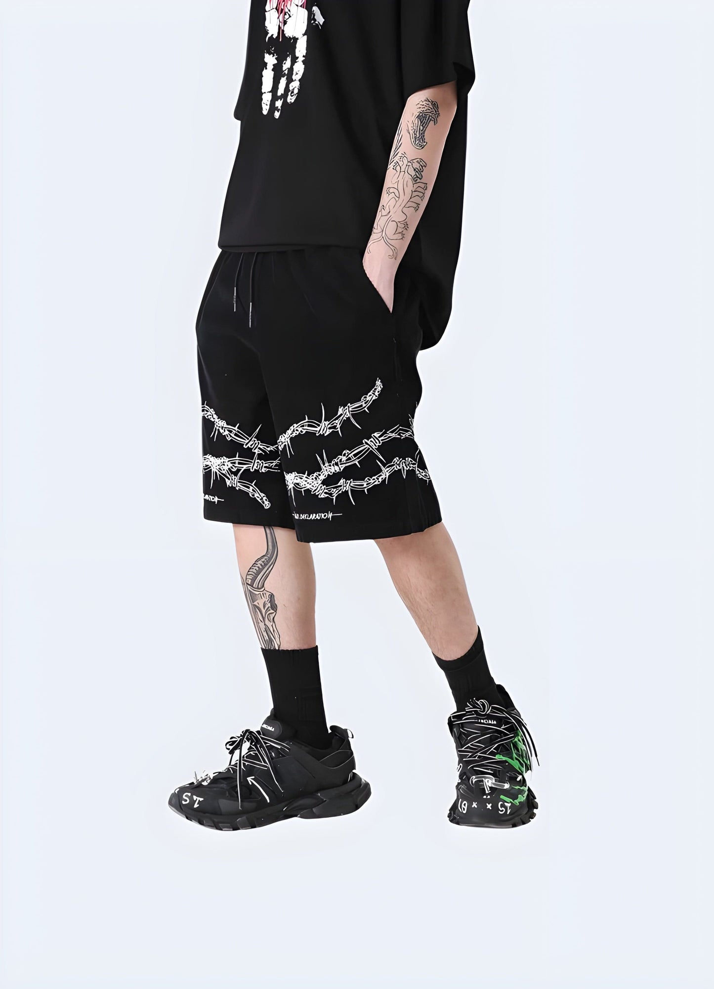 Front side view of a man wearing barbed wire shorts, highlighting the unconventional style and attention-grabbing details, suitable for the UK alternative fashion enthusiast.