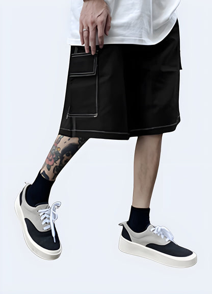 Front side view of a man wearing trendy black shorts with eye-catching white stitching, showcasing the garment's modern silhouette, high-quality construction, and attention to detail that elevate any casual outfit.