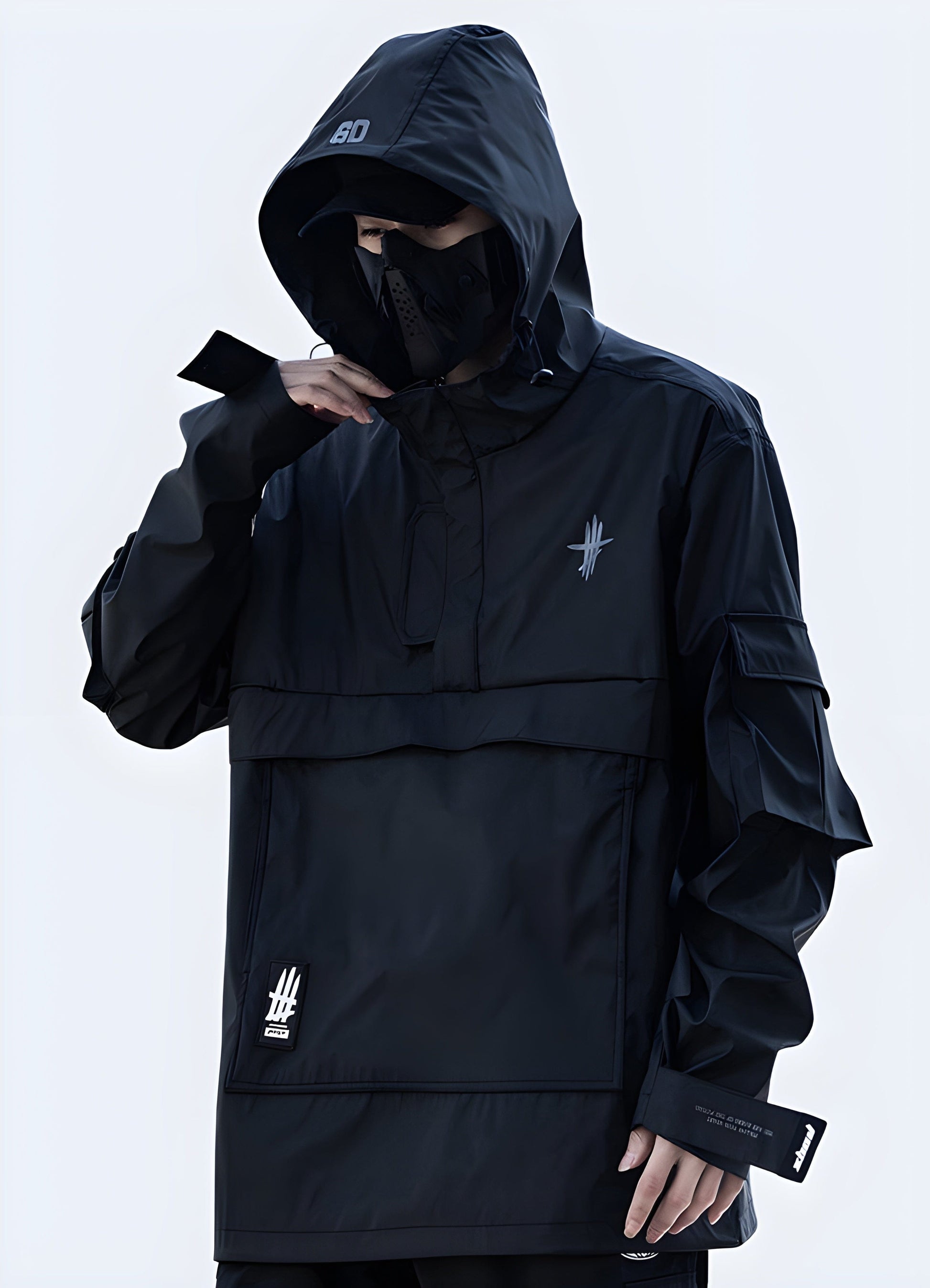 Front view of a man wearing a black techwear windbreaker jacket, showcasing its modern design and functional features, perfect for fashion-forward UK customers.