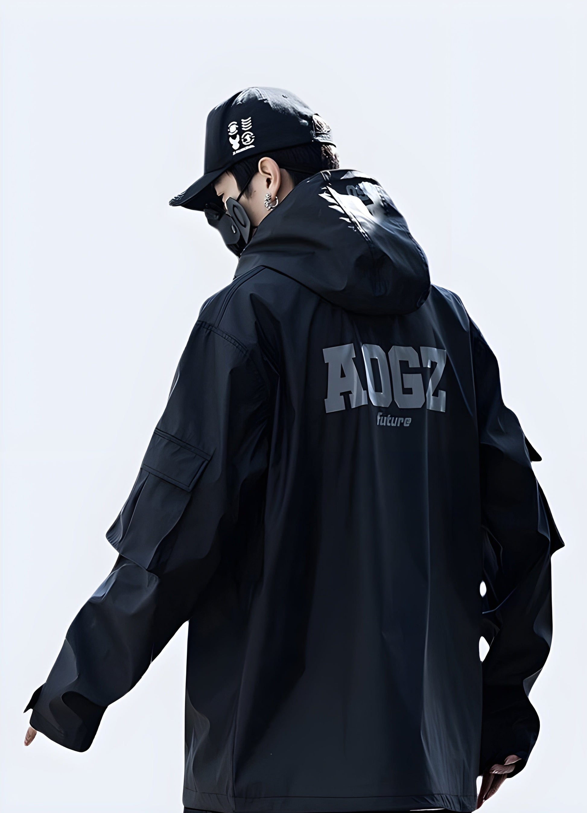 Back view of a man wearing a sleek black techwear windbreaker, highlighting its streamlined silhouette and advanced materials, ideal for active UK individuals.