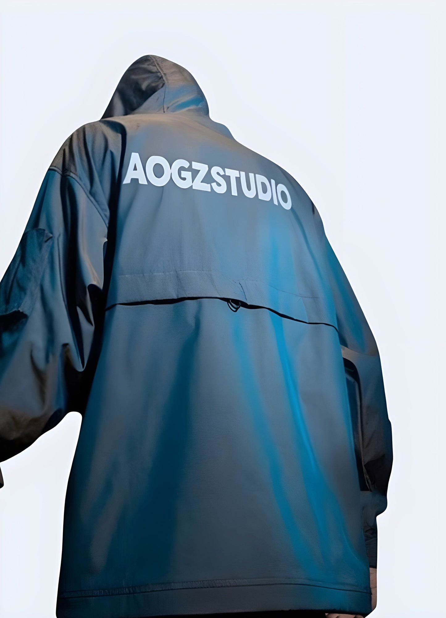 Back view of a man wearing a blue techwear jacket, highlighting its streamlined silhouette and innovative features, perfect for active UK consumers.