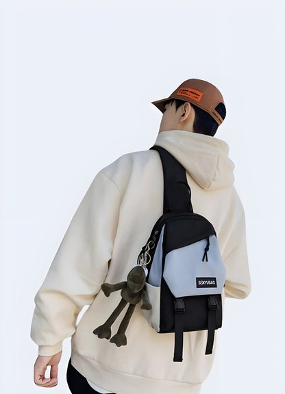  Side view of a model presenting a white crossbody chest bag, emphasizing its sleek profile for UK fashion enthusiasts.