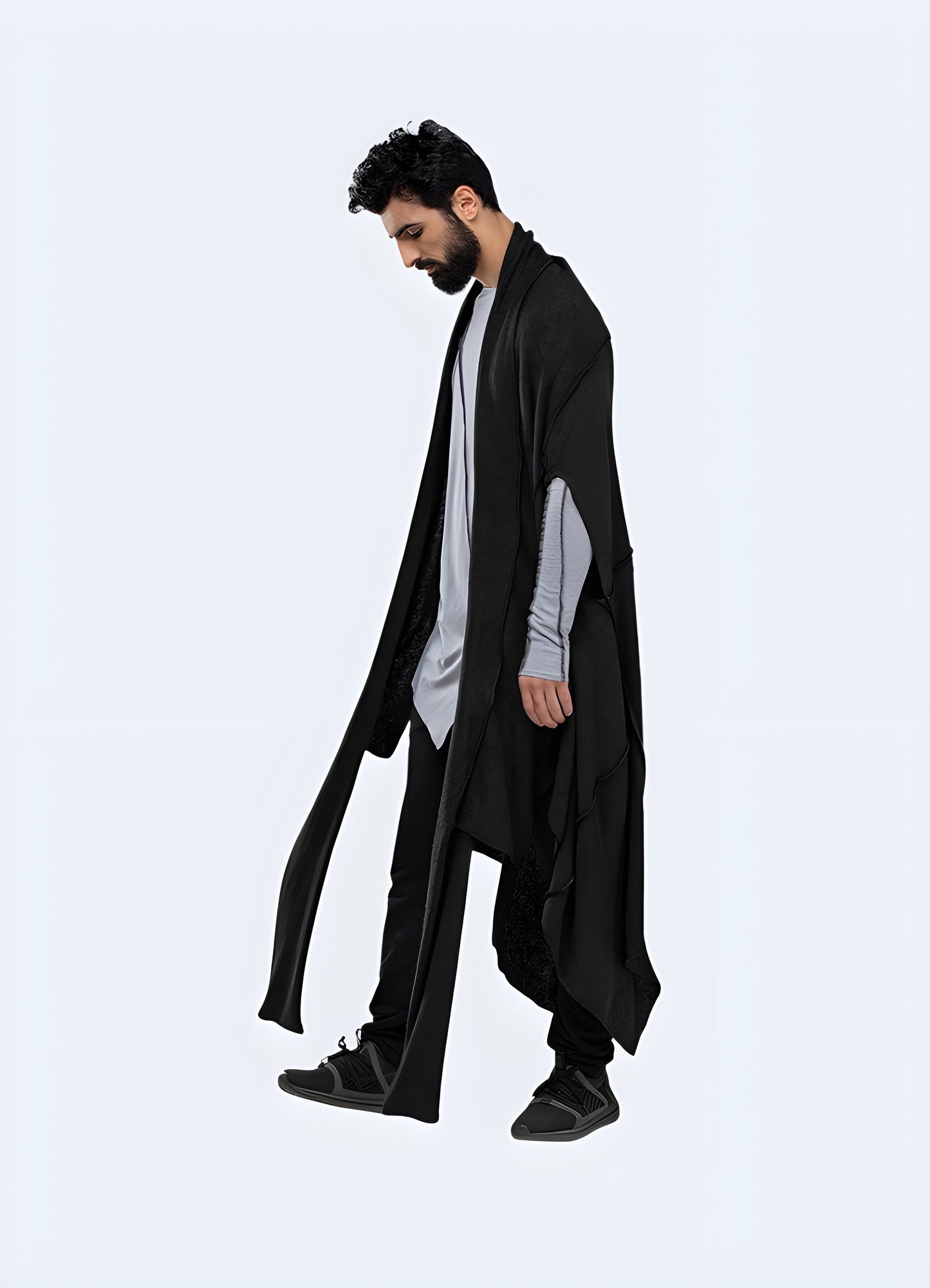 Side view of a man wearing a cyberpunk poncho, showcasing the unconventional design and futuristic elements, perfect for standing out in the UK urban fashion scene.