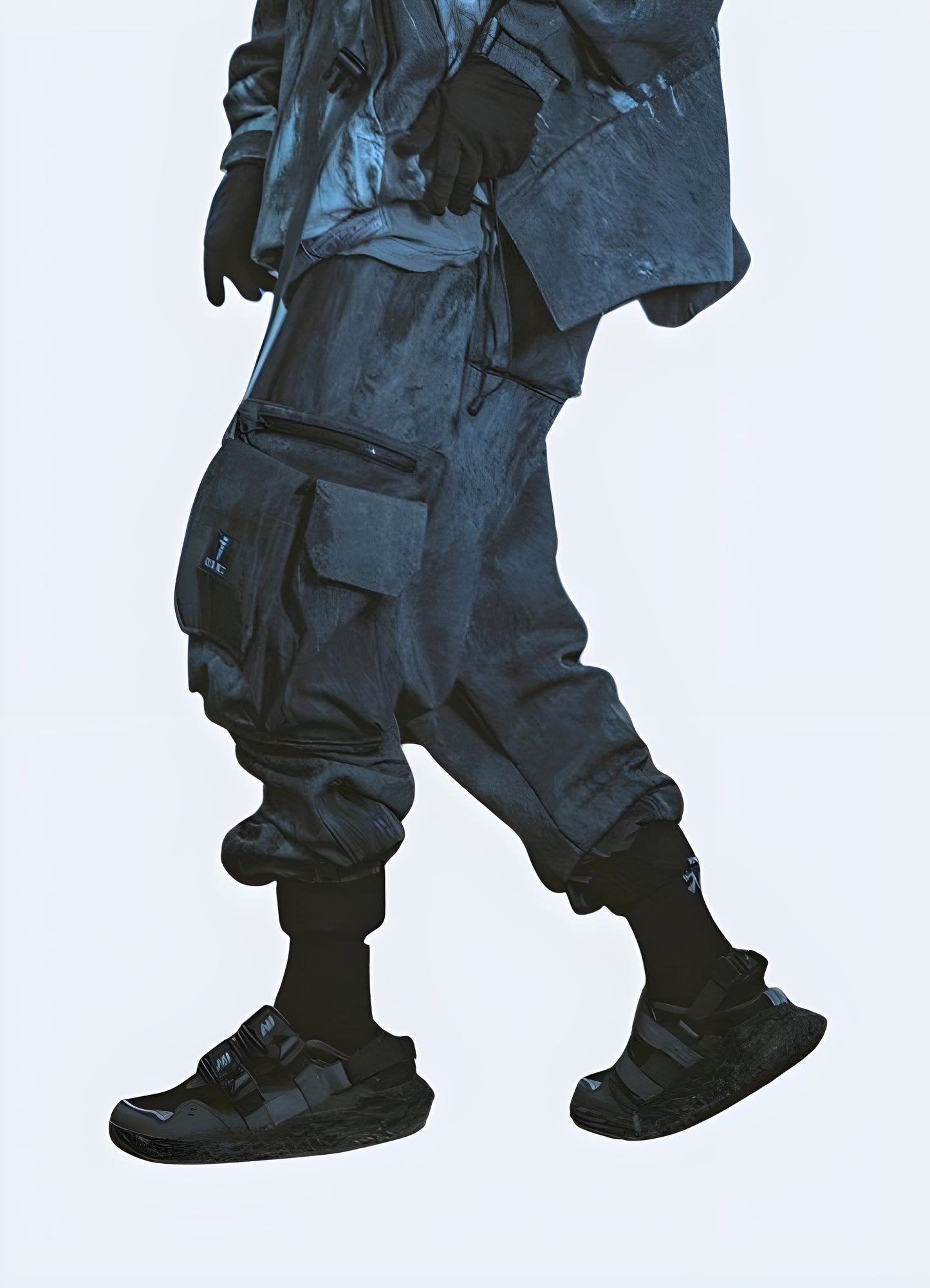 Side view of a man wearing dark grey cargo pants, highlighting the design features and silhouette from the side angle.