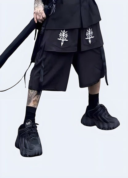 Front view of a man sporting cutting-edge darkwear shorts, showcasing the garment's black color palette, avant-garde silhouette, and meticulous craftsmanship that epitomize the darkwear fashion movement.