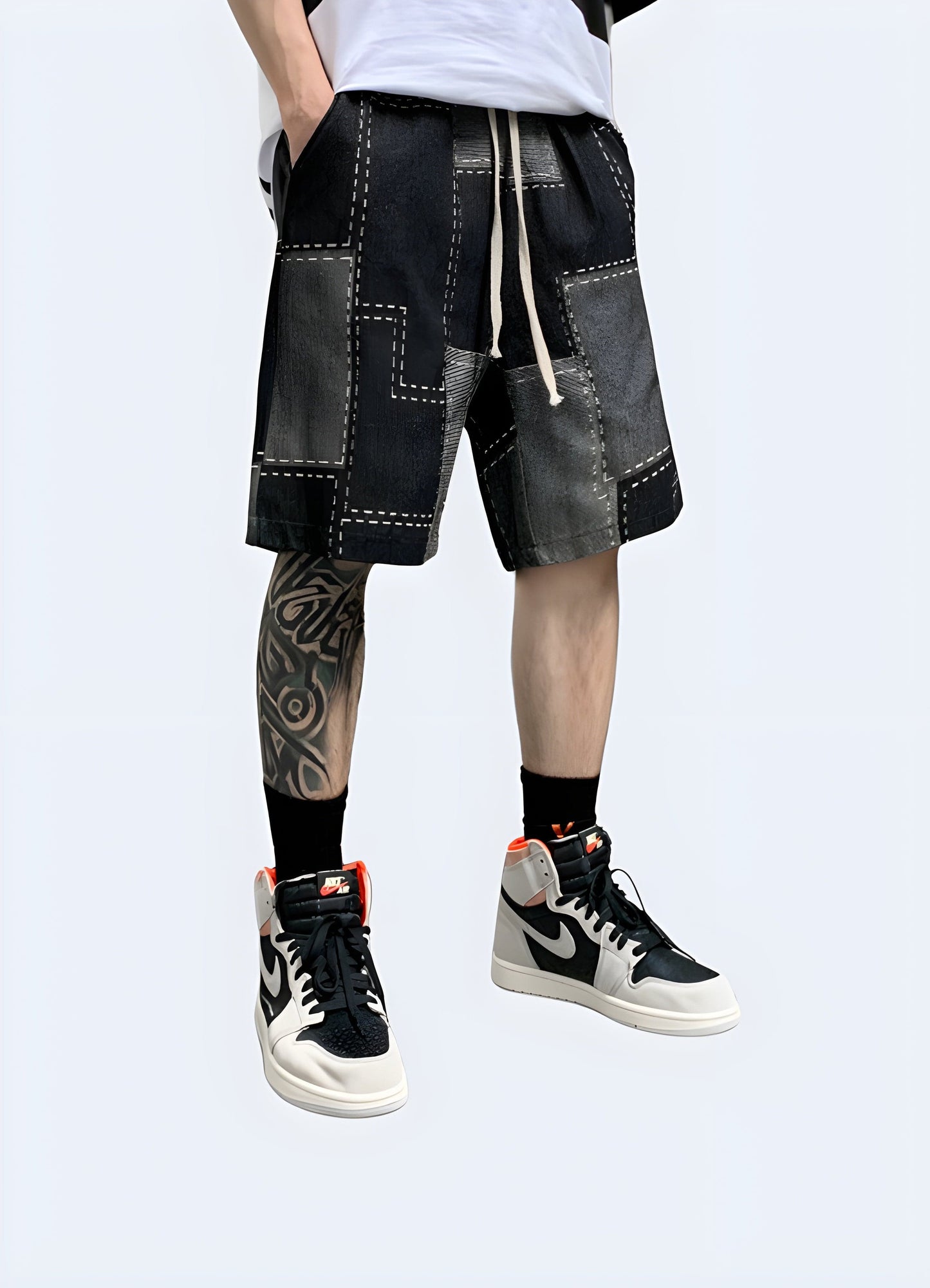 Front view of a man wearing denim patchwork shorts, showcasing the creative design and trendy look, perfect for the UK fashion-forward individual.