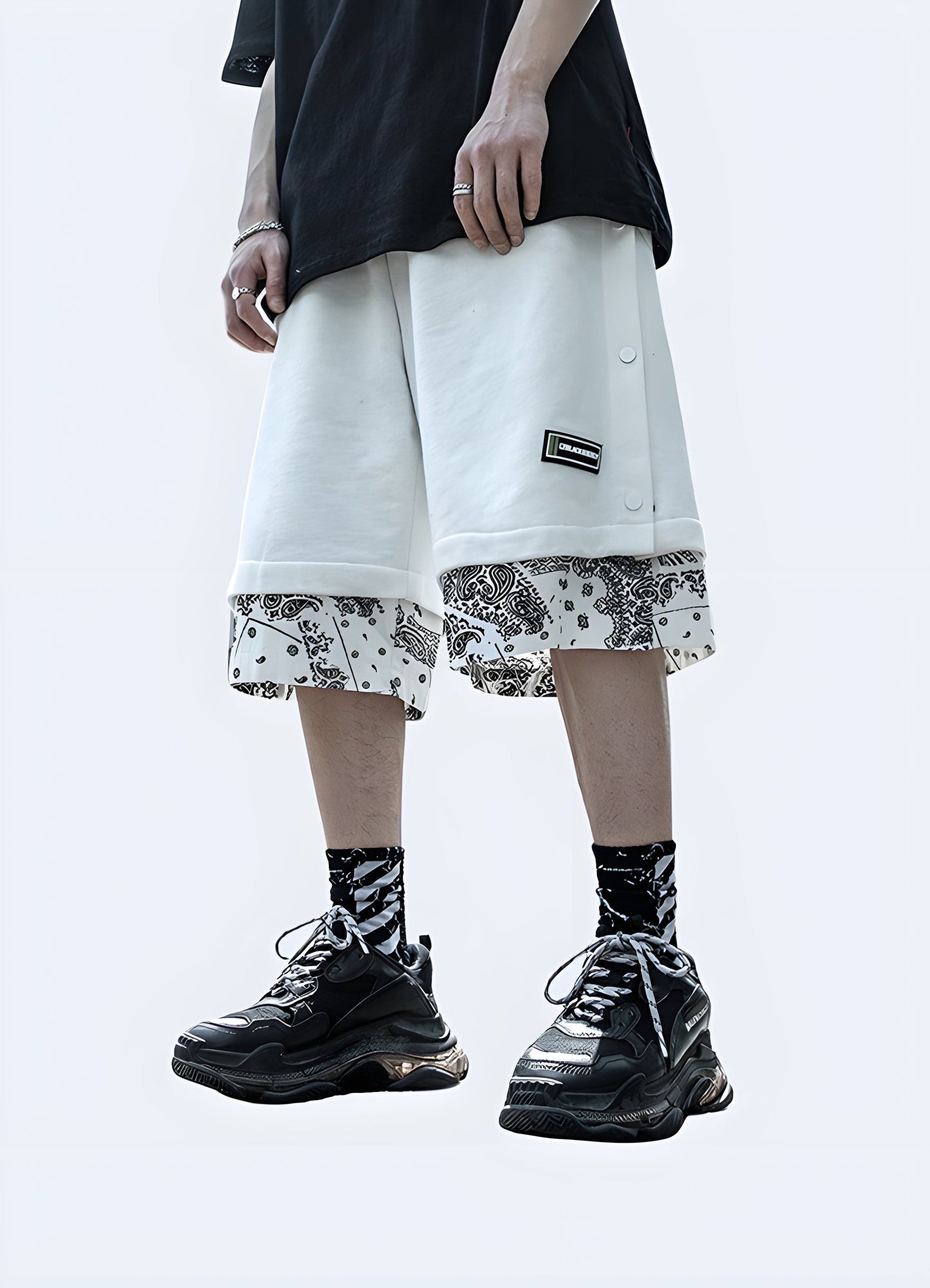 Front view of a man wearing black and white bandana shorts, highlighting the bold contrast and fashionable design, perfect for the UK urban fashion scene.