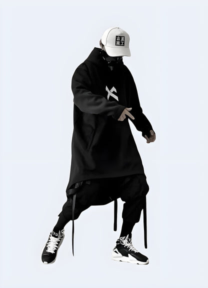 Front view of a man wearing a futuristic poncho, showcasing the sleek and modern aesthetic, ideal for making a statement in the UK urban fashion scene.