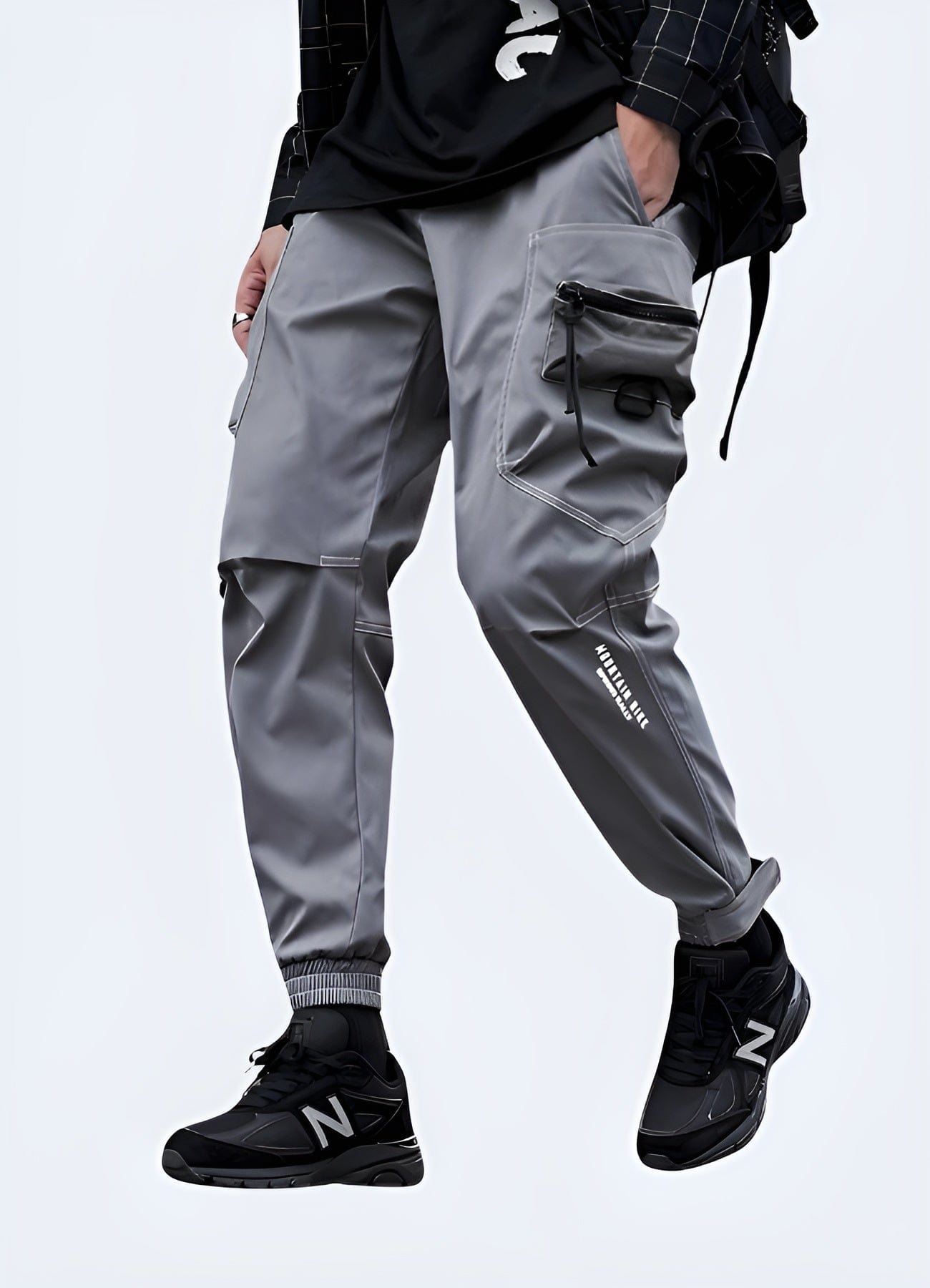 Front view of a man sporting contemporary grey skinny cargo pants, featuring a streamlined fit and functional pockets, ideal for fashion-forward men in the UK.