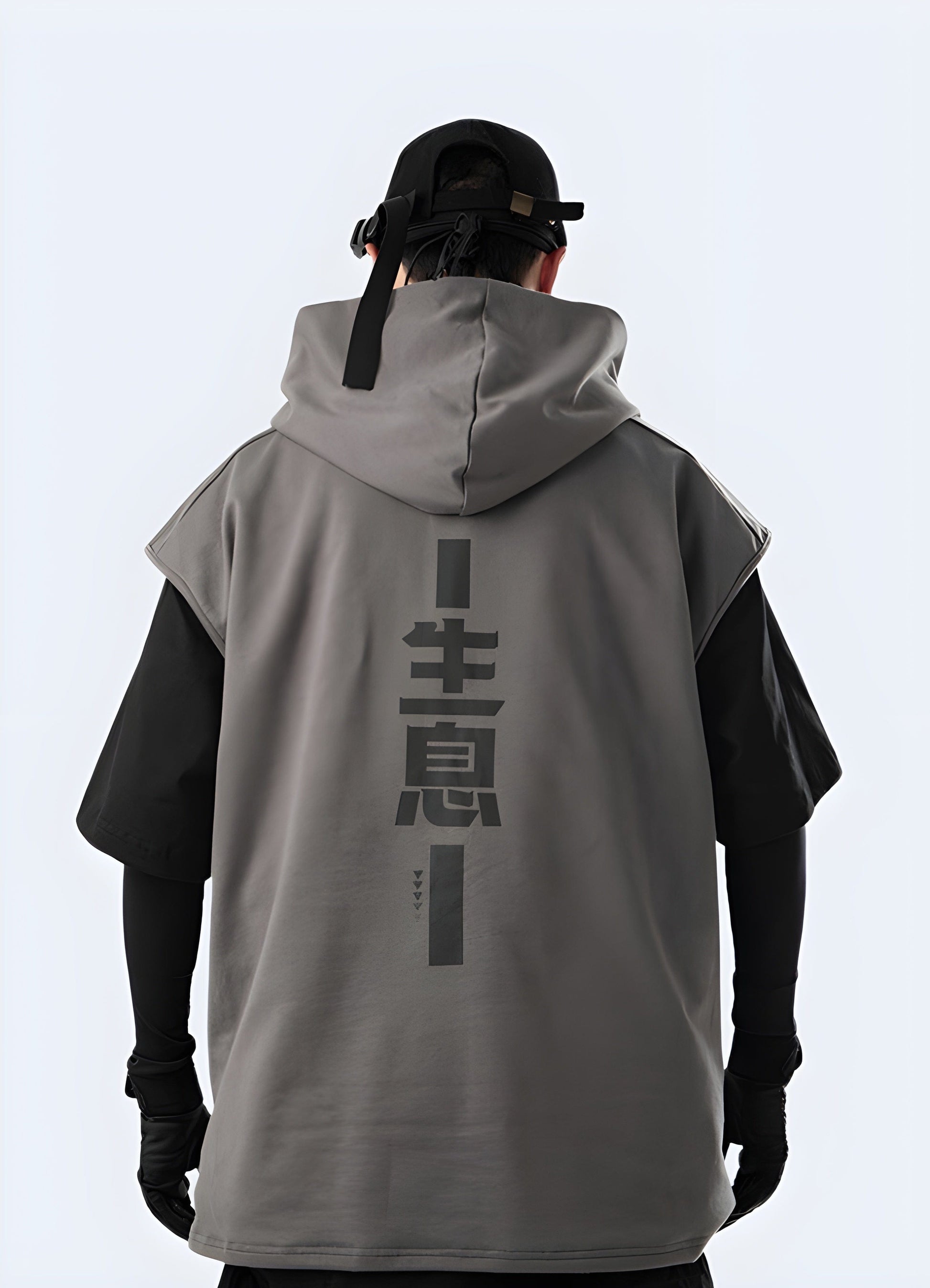 A man wearing a black Japanese techwear hoodie with a minimalist design and a sleek, modern aesthetic, photographed from the back.