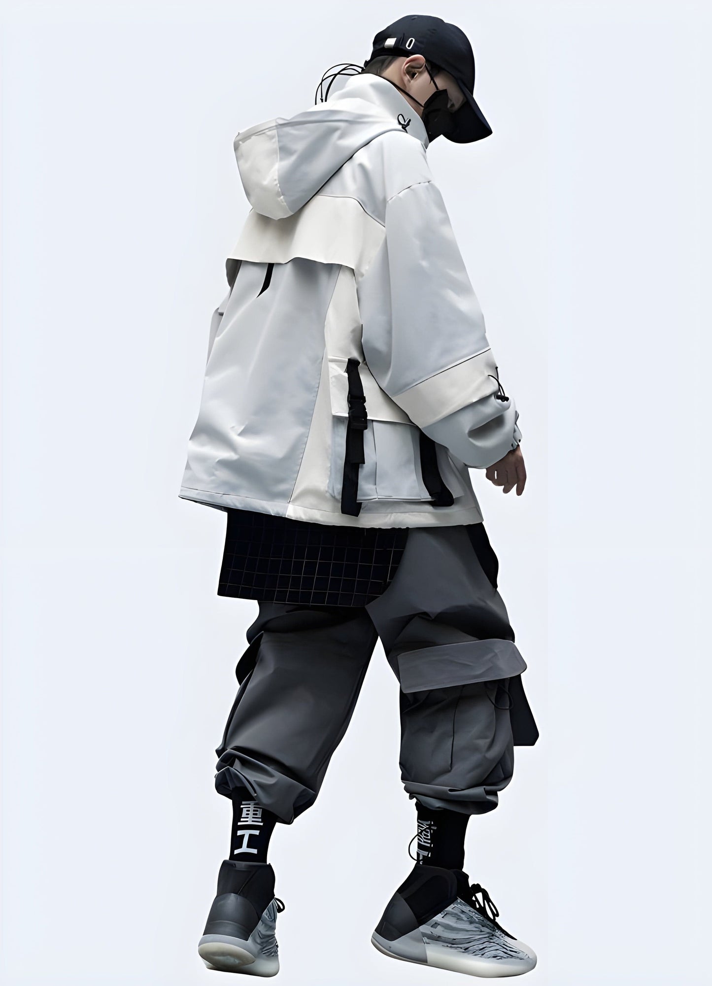 Man wearing a sleek black techwear windbreaker with striking white Japanese kanji text, showcasing the full back view of the garment in the UK.