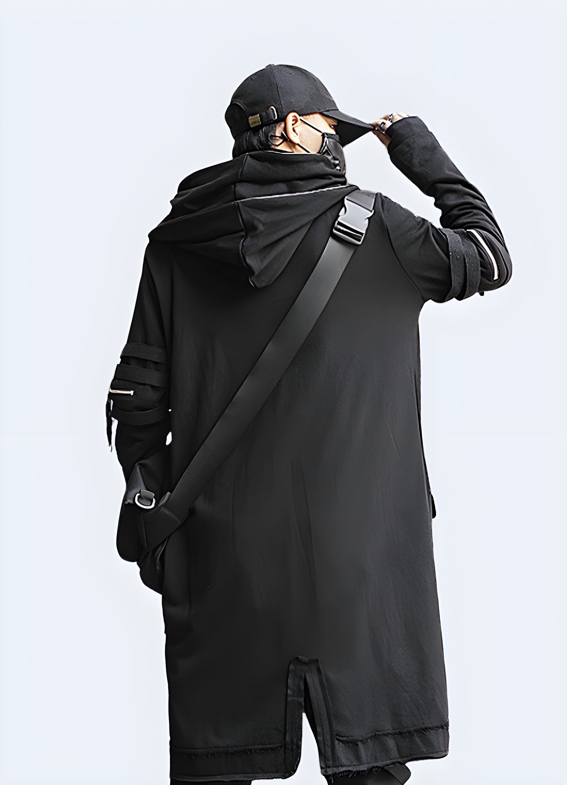 Back view of a man wearing a long techwear jacket, showcasing its unique silhouette and advanced features, perfect for UK's style-conscious consumers seeking a statement piece.