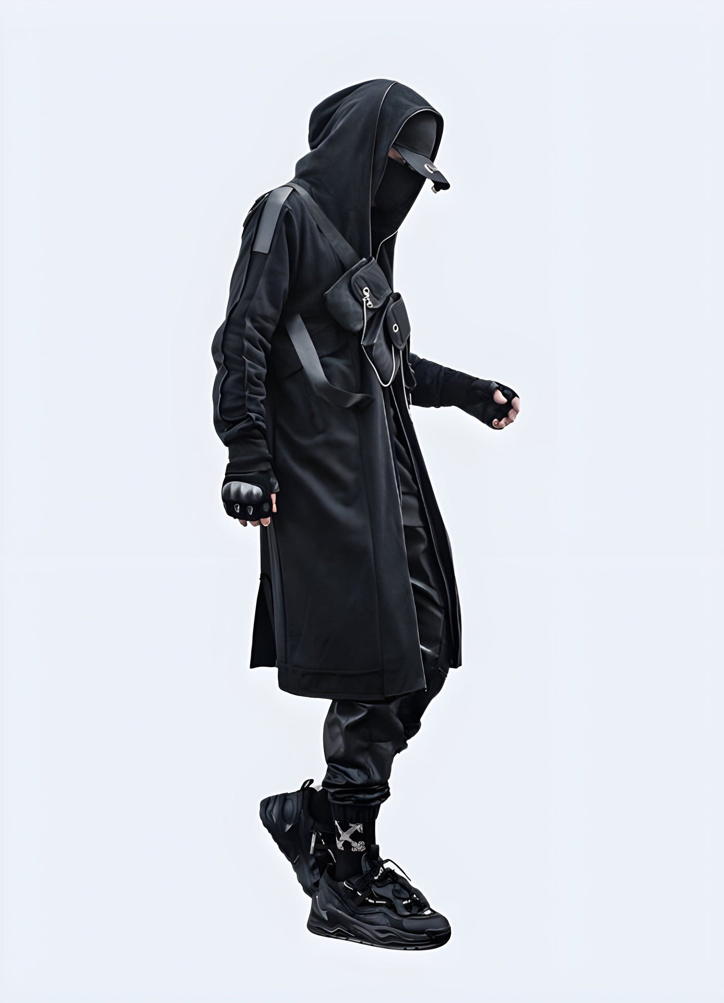 Model showcasing a sleek techwear overcoat from the side view, highlighting its modern design and practical features for UK customers.