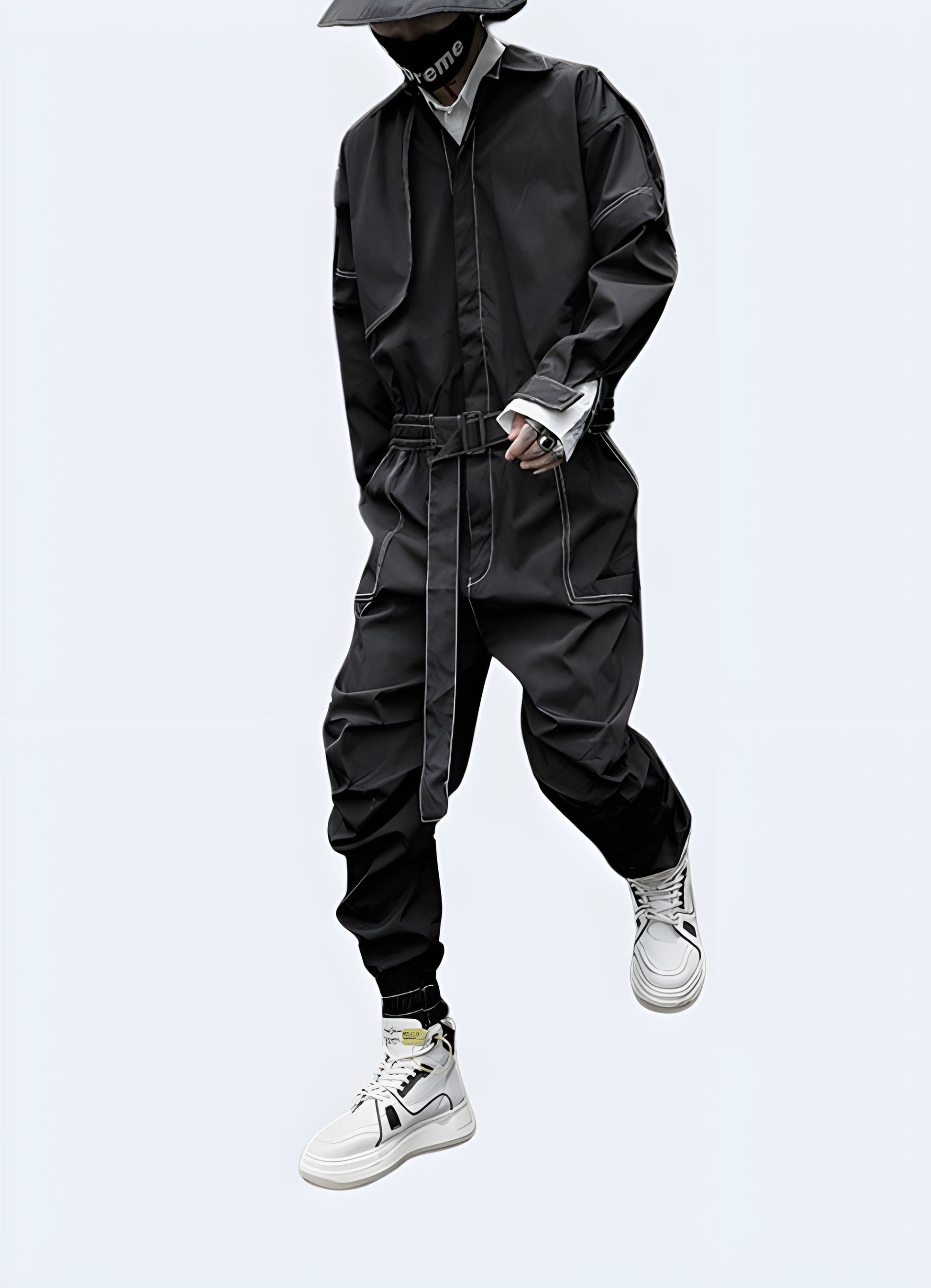 Front view of a man wearing an innovative streetwear cargo coverall with distinctive style features, posing on a city street in UK.