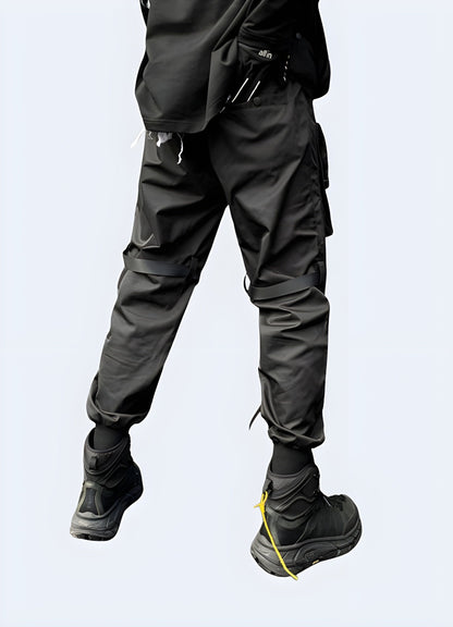  Back side view of a man modeling stylish streetwear joggers, highlighting the premium materials and attention to detail, a must-have for UK streetwear enthusiasts seeking both comfort and style.