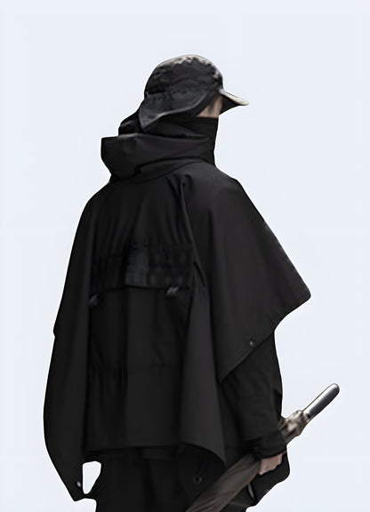 Back view of a man wearing a tactical cloak, showcasing its rugged construction and practical features for navigating challenging environments in the UK.