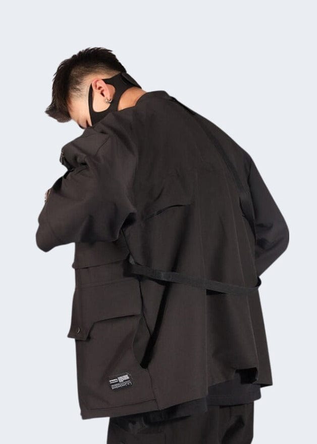 Back view of a man wearing a tactical kimono, showcasing the practical features and unique silhouette, ideal for the UK fashion-conscious adventurer.