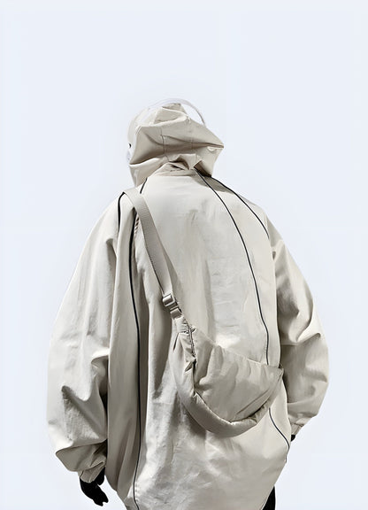 Back view of a man wearing a white tactical poncho hoodie, featuring the adjustable hood and durable construction, suitable for various weather conditions in the UK.