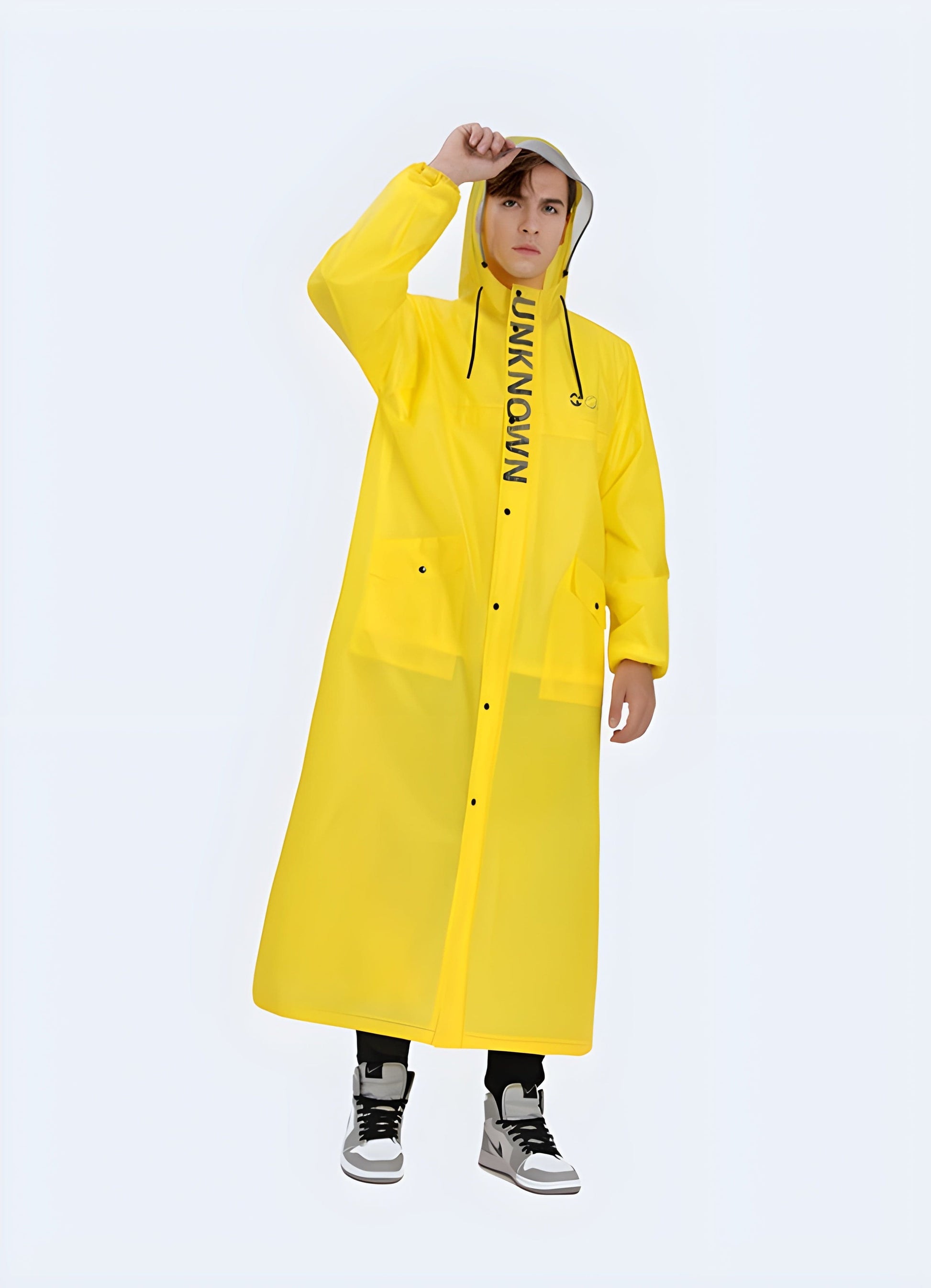 Front view of a man wearing a yellow technical poncho, featuring high-visibility color and functional design, suitable for outdoor activities in the UK.