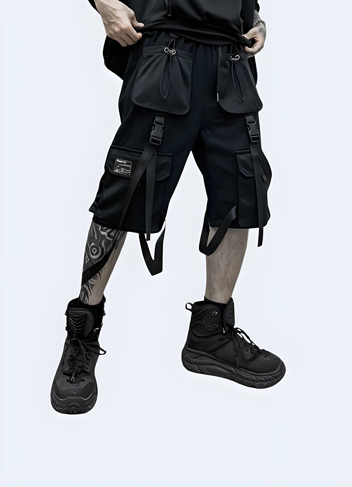 Front view of a man wearing black techwear cargo shorts, showcasing the modern design and practical features suitable for the UK streetwear scene.